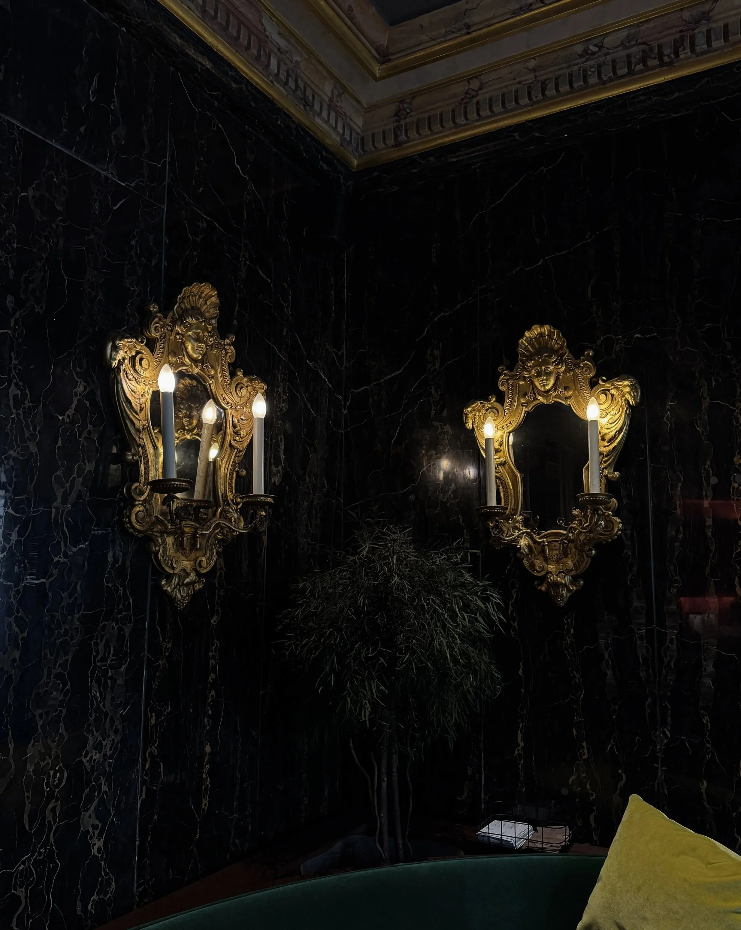 Historic marble lounge with ornate mirrors and timeless decorative details