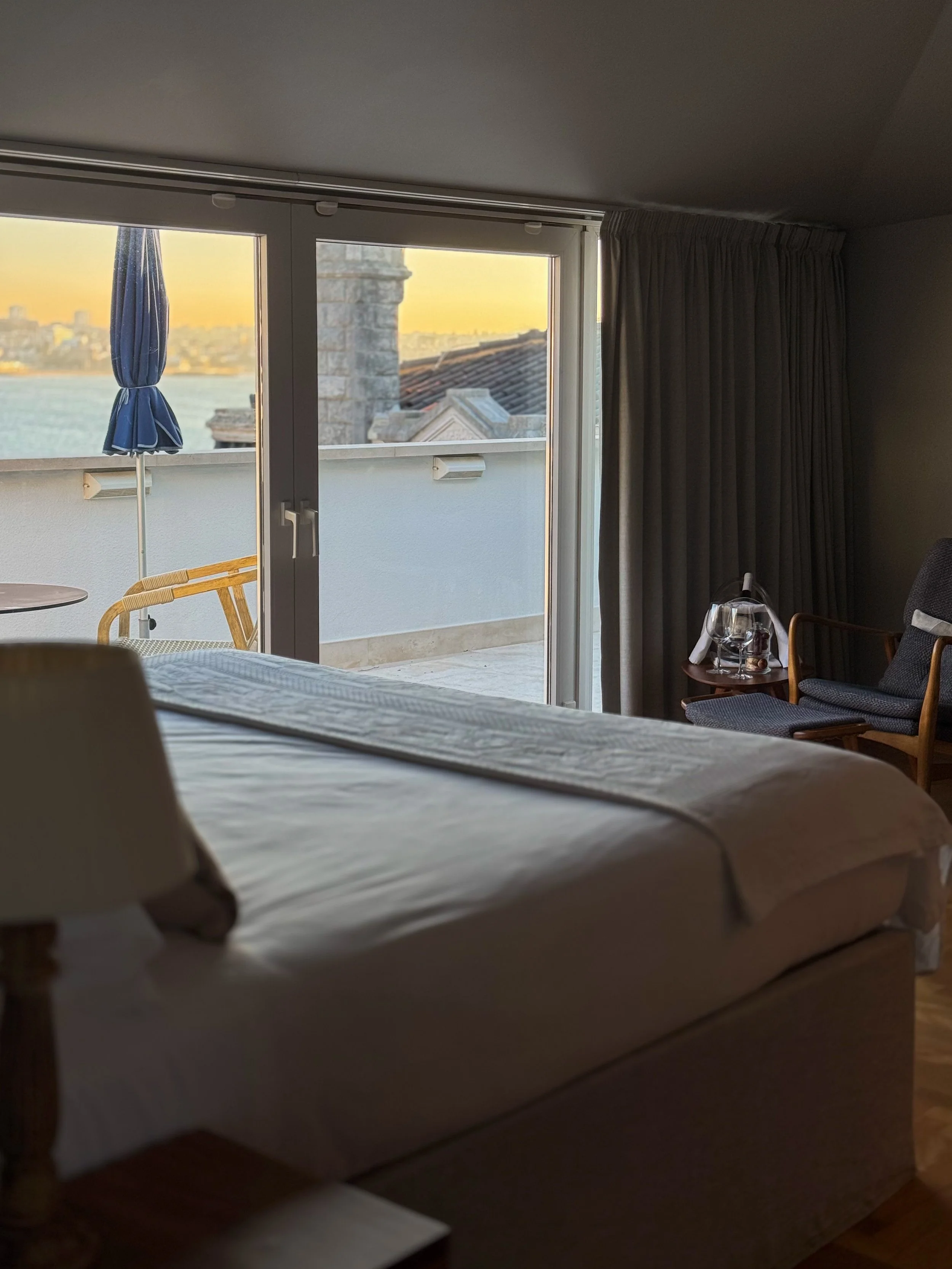 Luxury guest room with private terrace overlooking the Atlantic Ocean and Cascais waterfront
