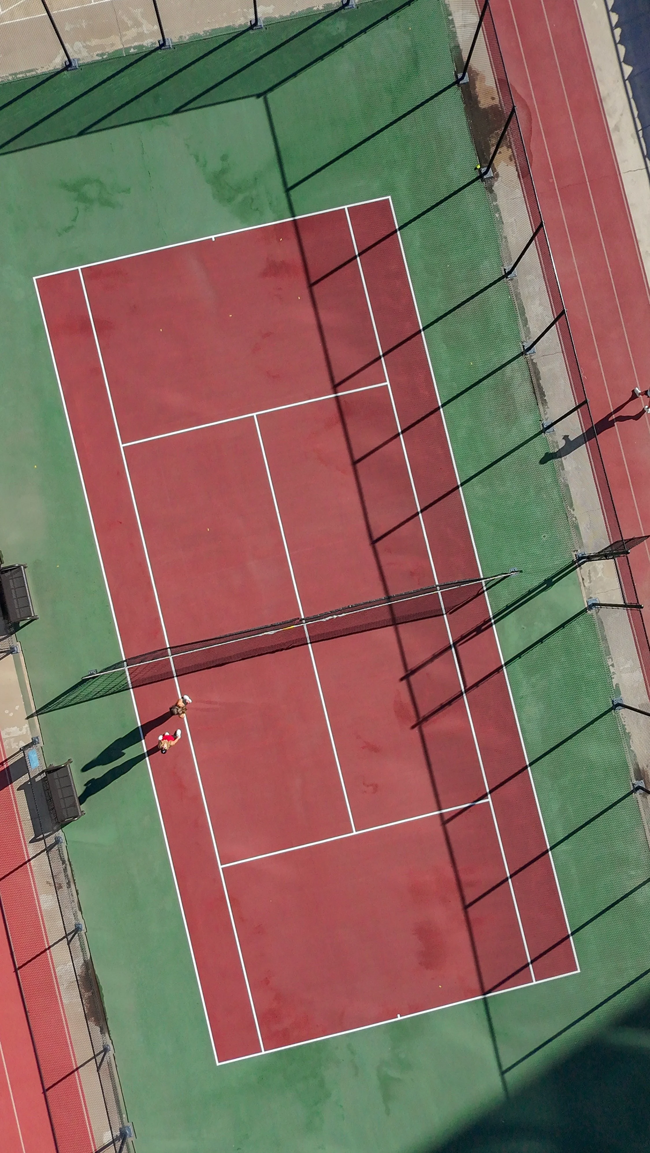 Aerial view of the rooftop tennis court surrounded by downtown Denver buildings