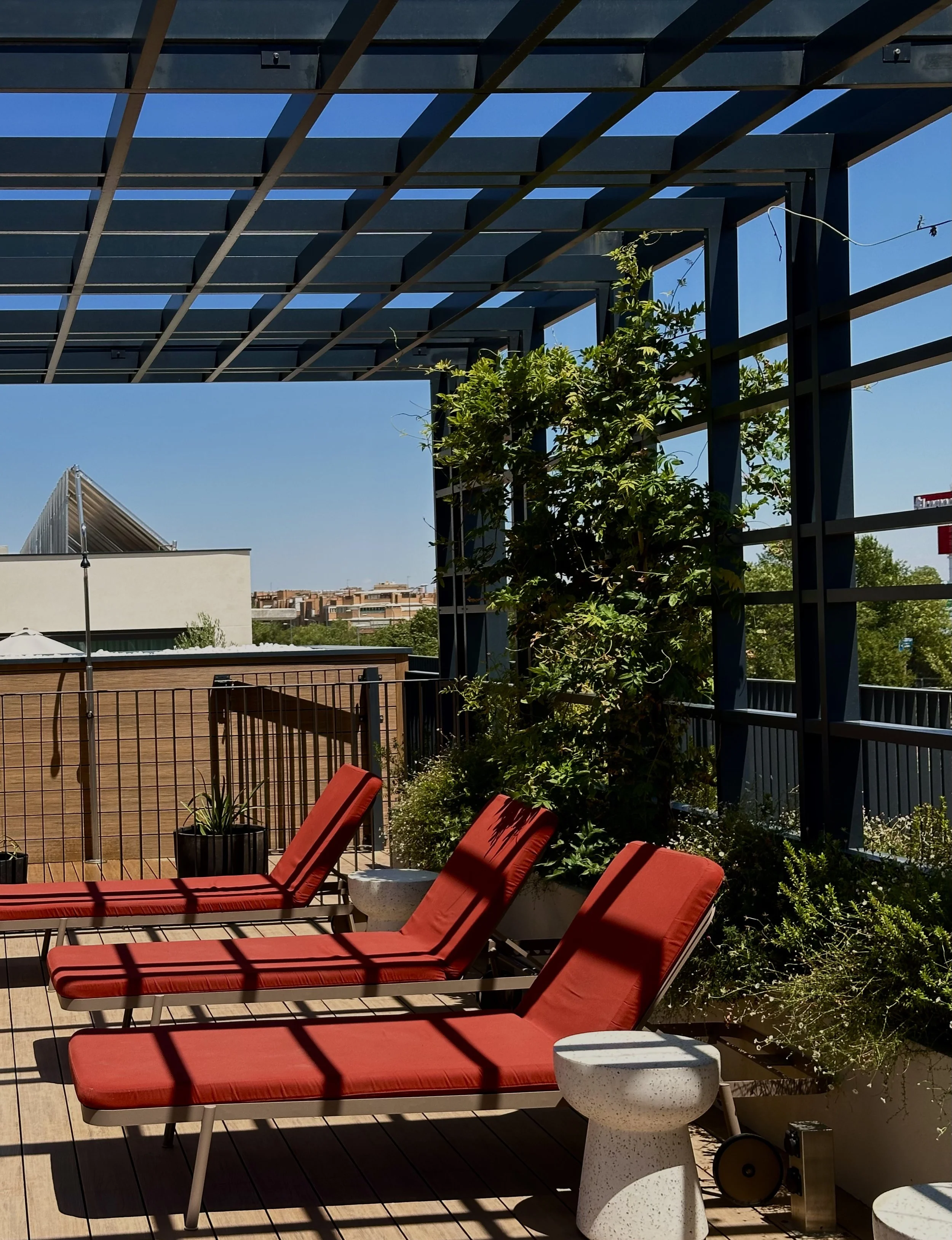 Rooftop sun terrace with loungers overlooking the Madrid skyline