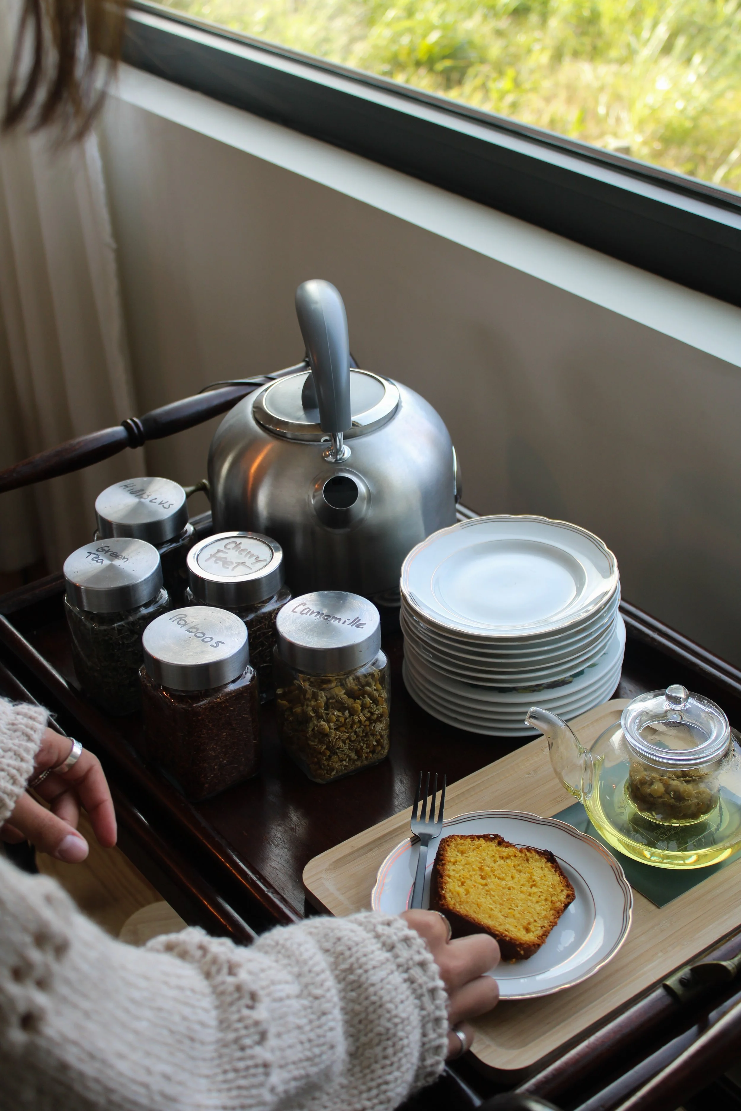 In-room tea setup with curated herbal selection and calm morning ambiance at Dream Guincho