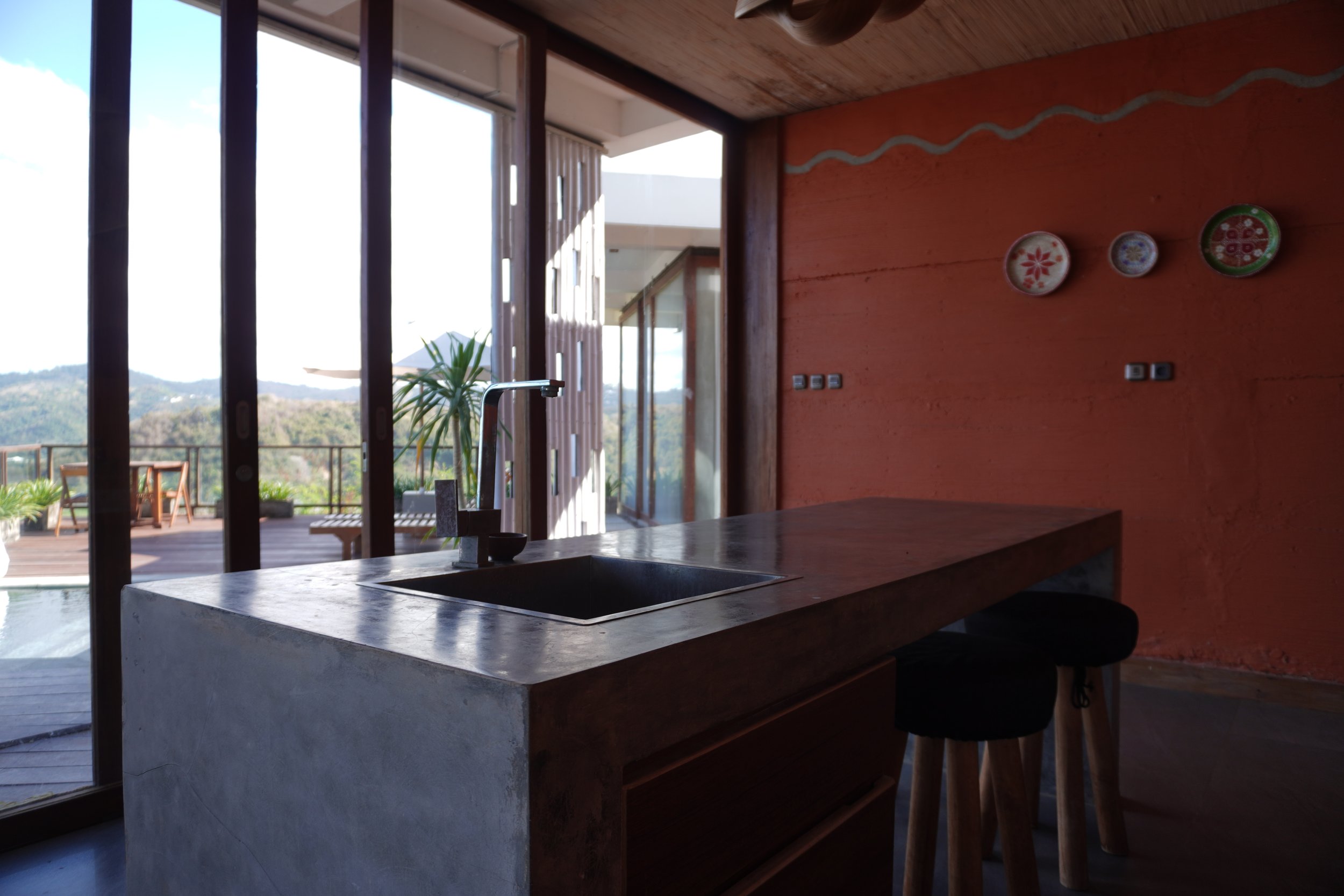 Modern villa kitchen with concrete island and mountain views