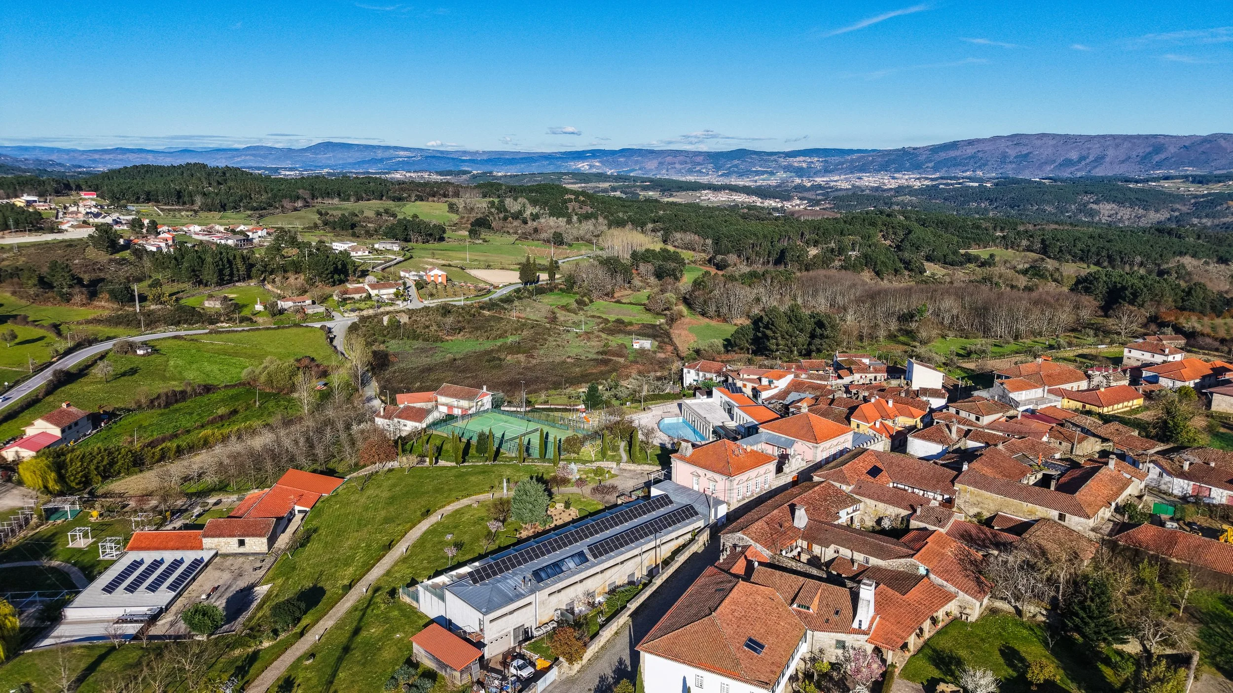 Elevated view of rural landscapes and traditional architecture nestled in northern Portugal’s scenic countryside, Casas Novas Countryside Hotel Spa & Events – Chaves, Portugal.