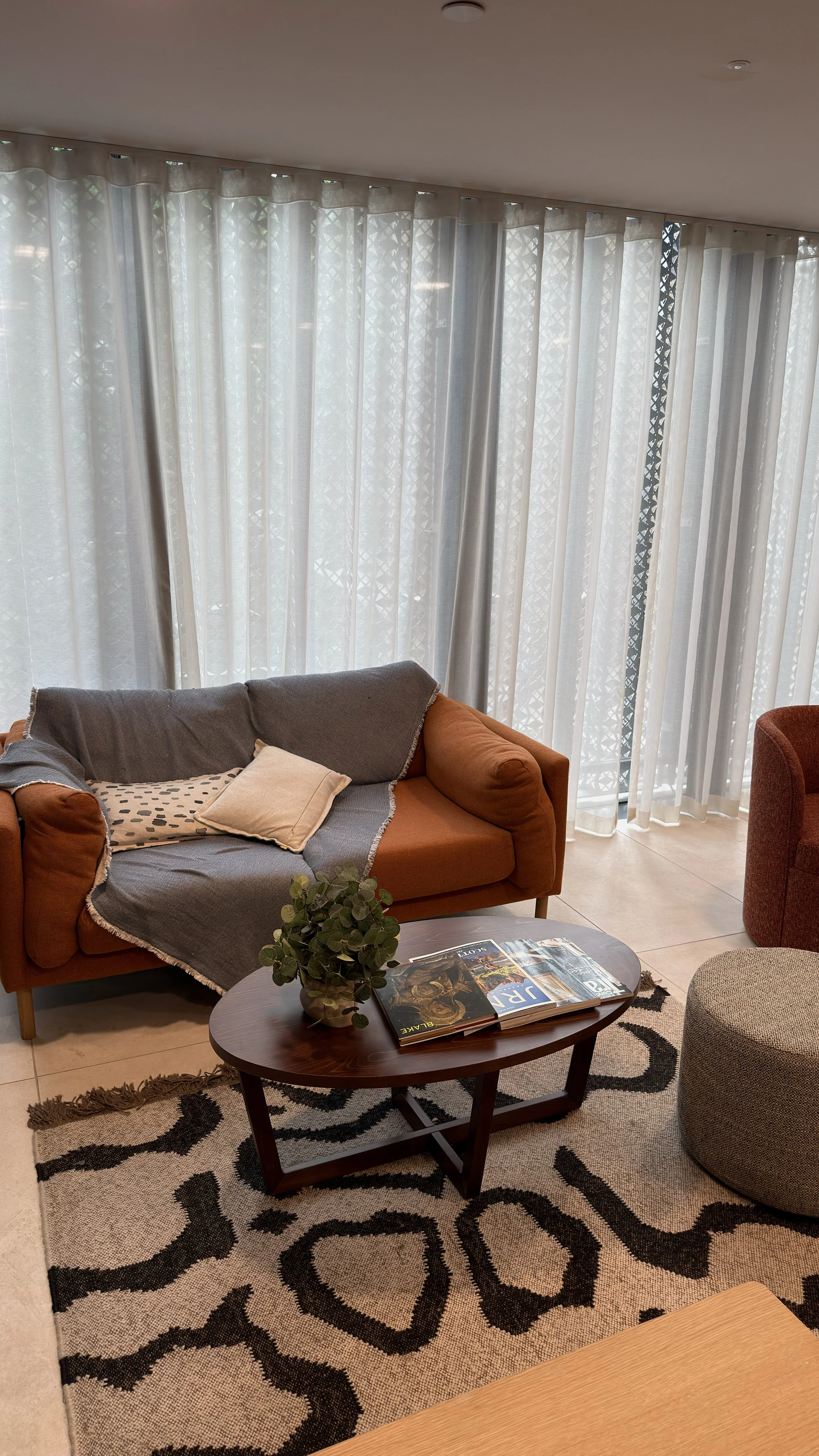 Bright contemporary living room with designer furnishings and floor-to-ceiling windows