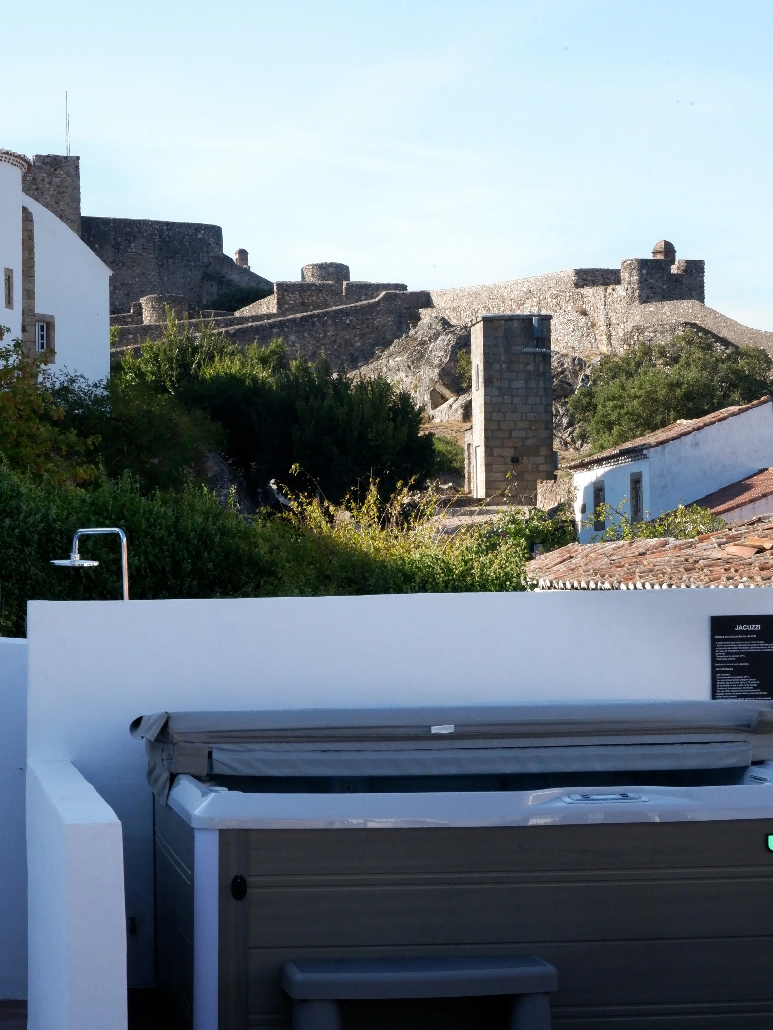 Private outdoor jacuzzi with views toward the historic stone walls of Marvão Castle