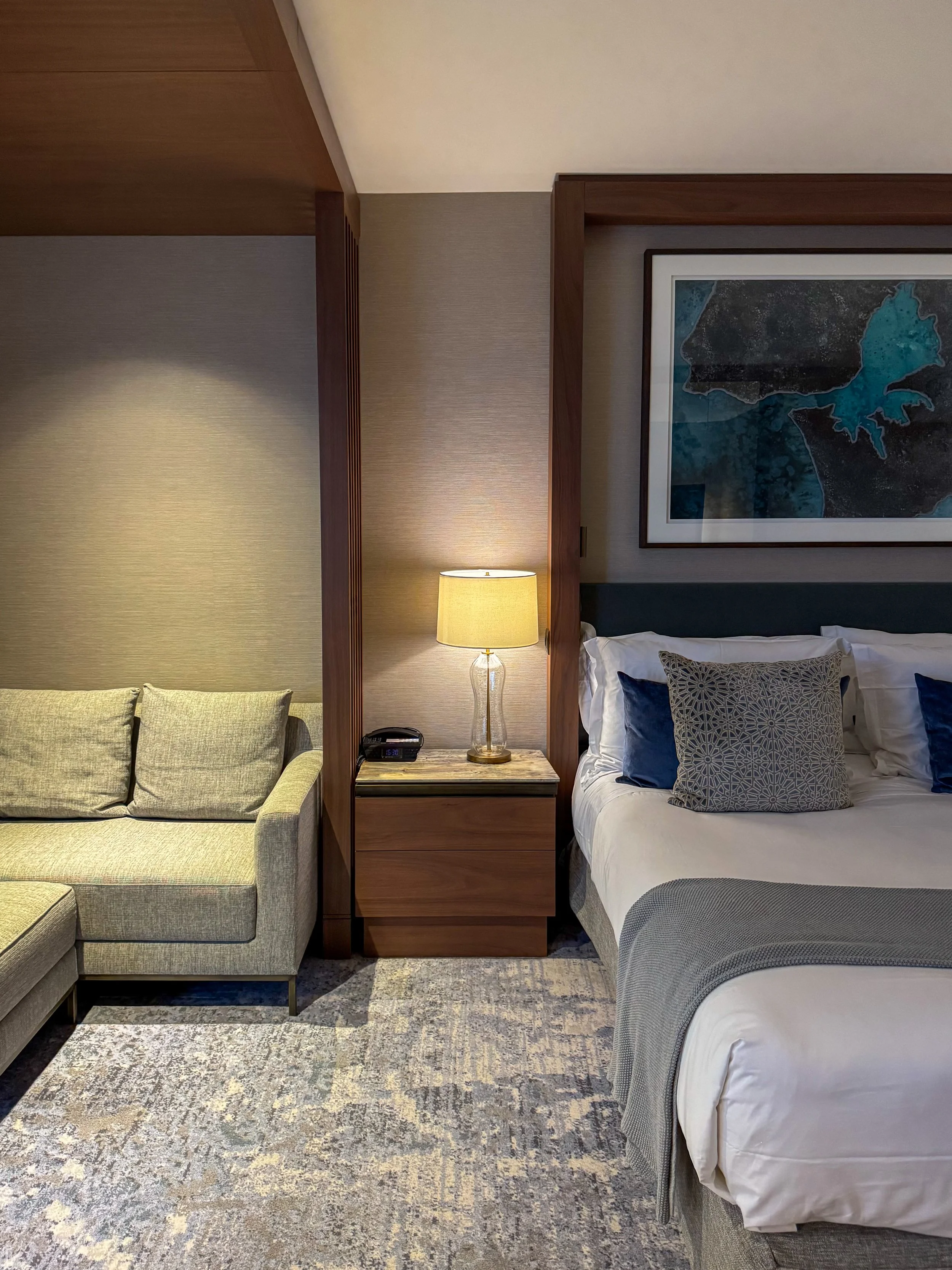 Spacious luxury guest room with king bed, lounge area, and contemporary interiors