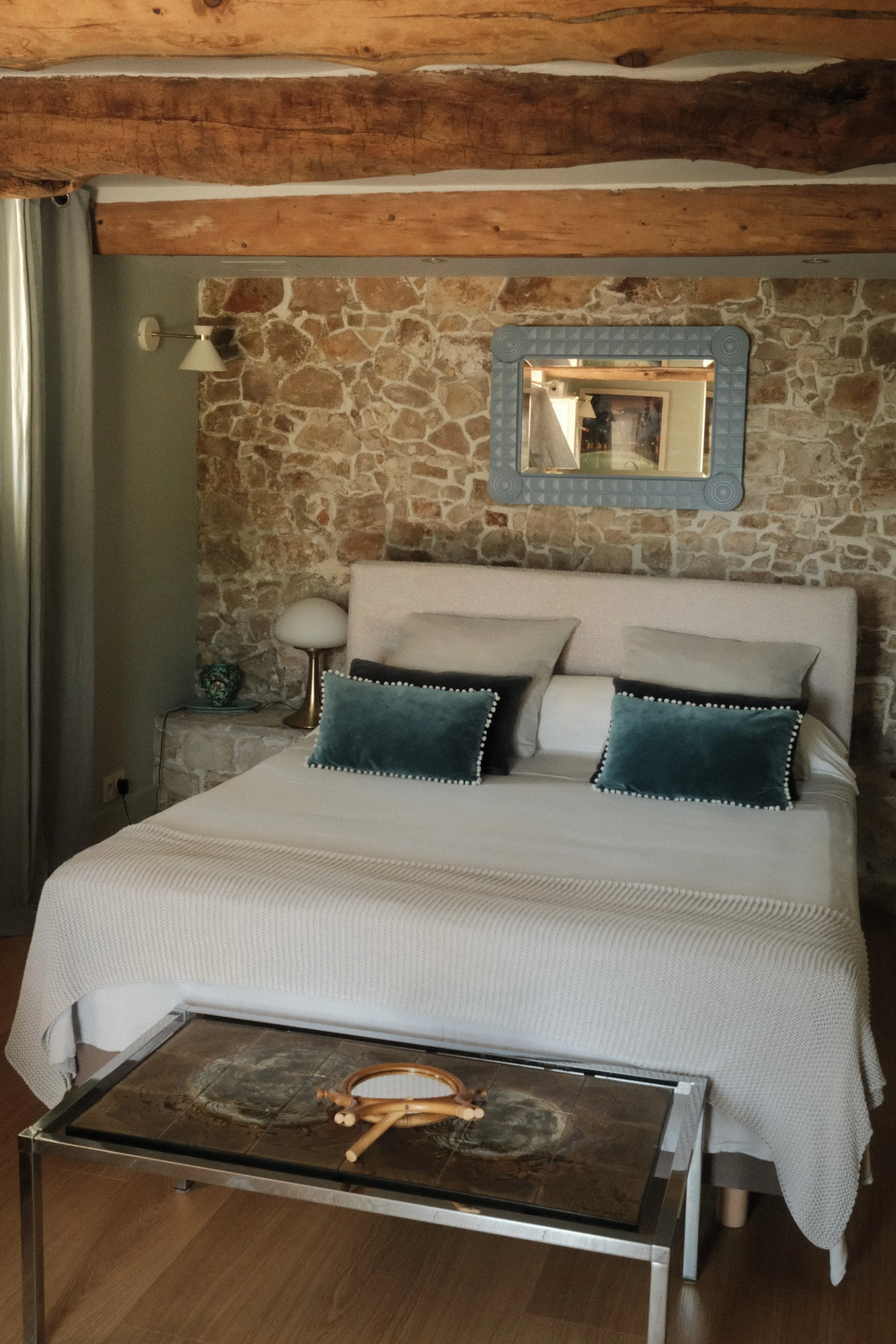 Stone and timber bedroom blending rustic charm with contemporary comfort