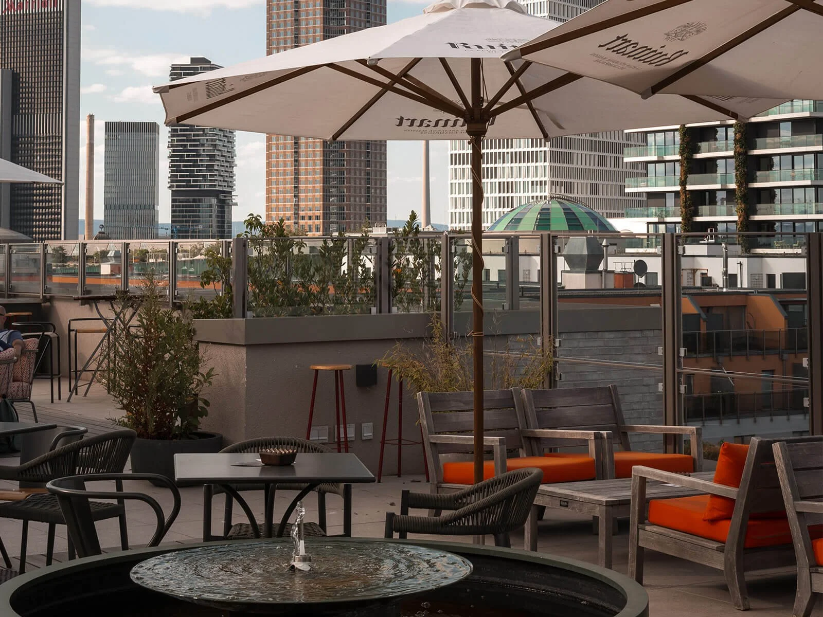 Rooftop terrace at Gekko House Frankfurt with urban skyline views and outdoor seating