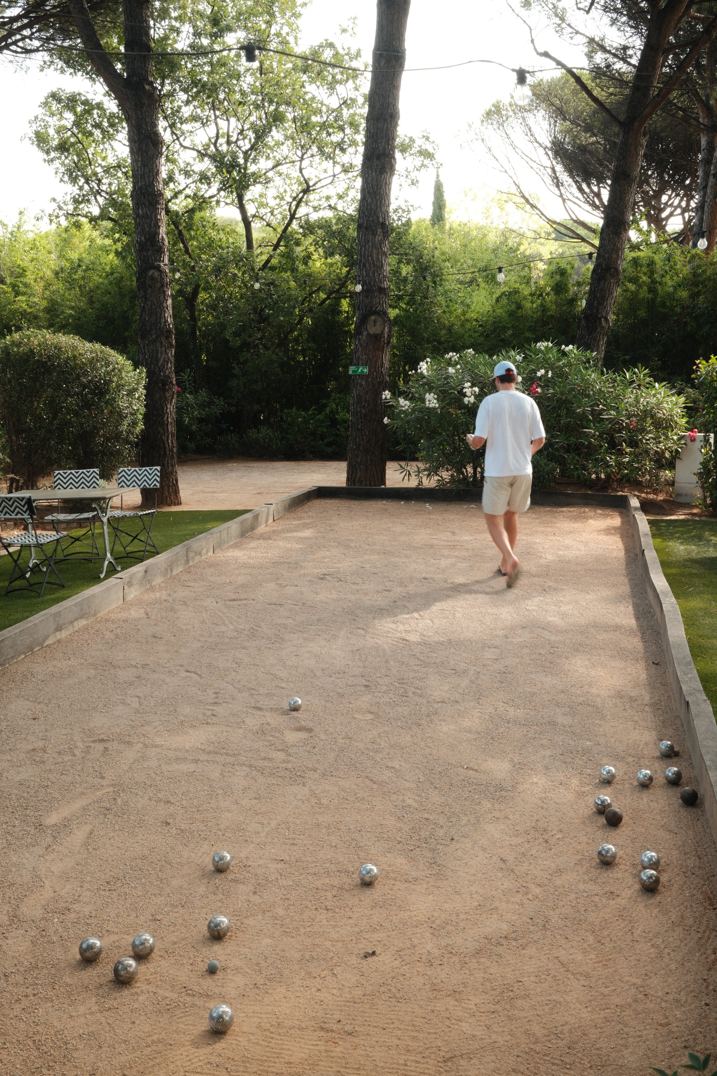 Traditional pétanque court surrounded by tranquil shaded gardens