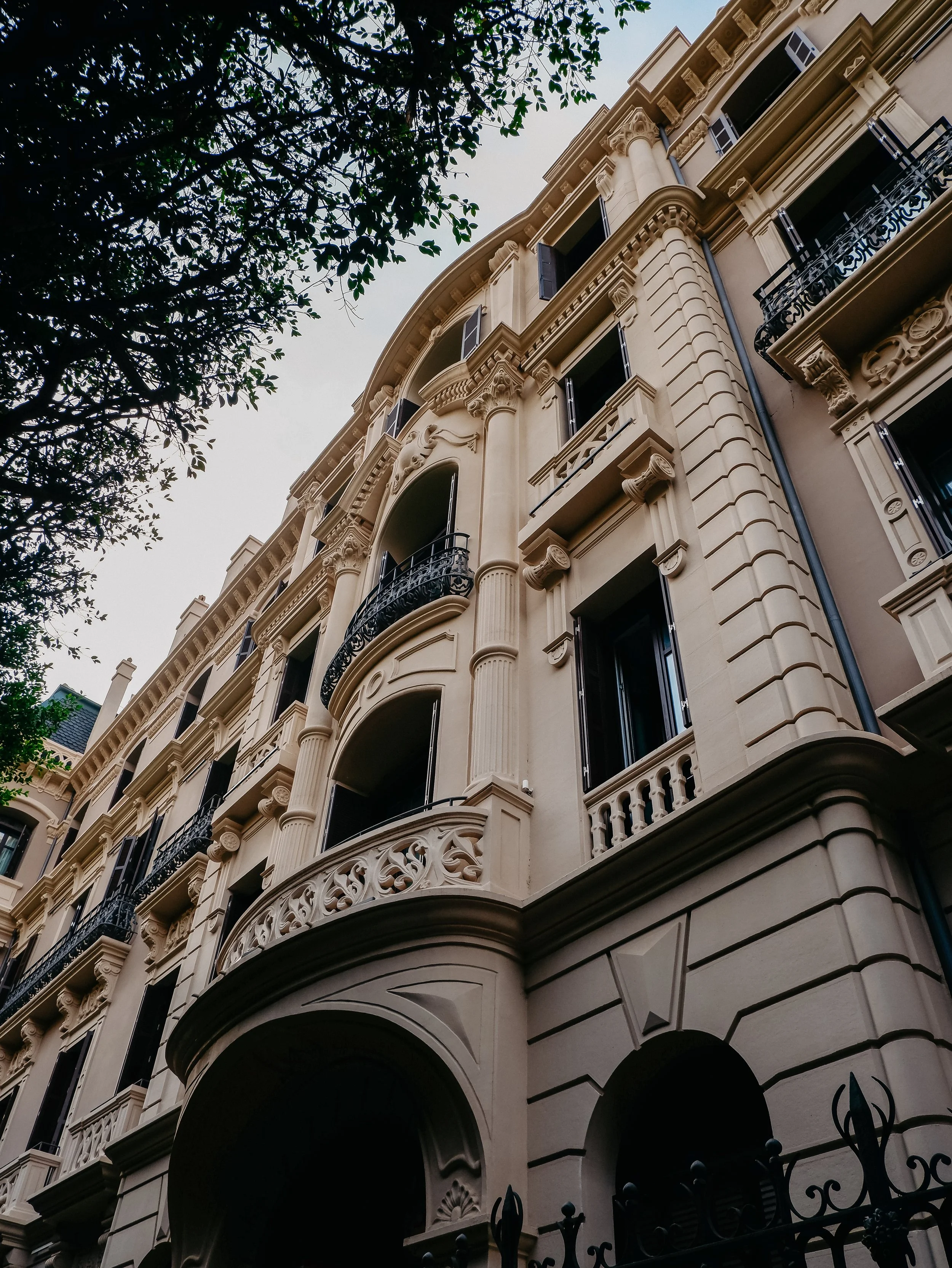 Historic palace façade showcasing grand neoclassical architecture and ornate balconies