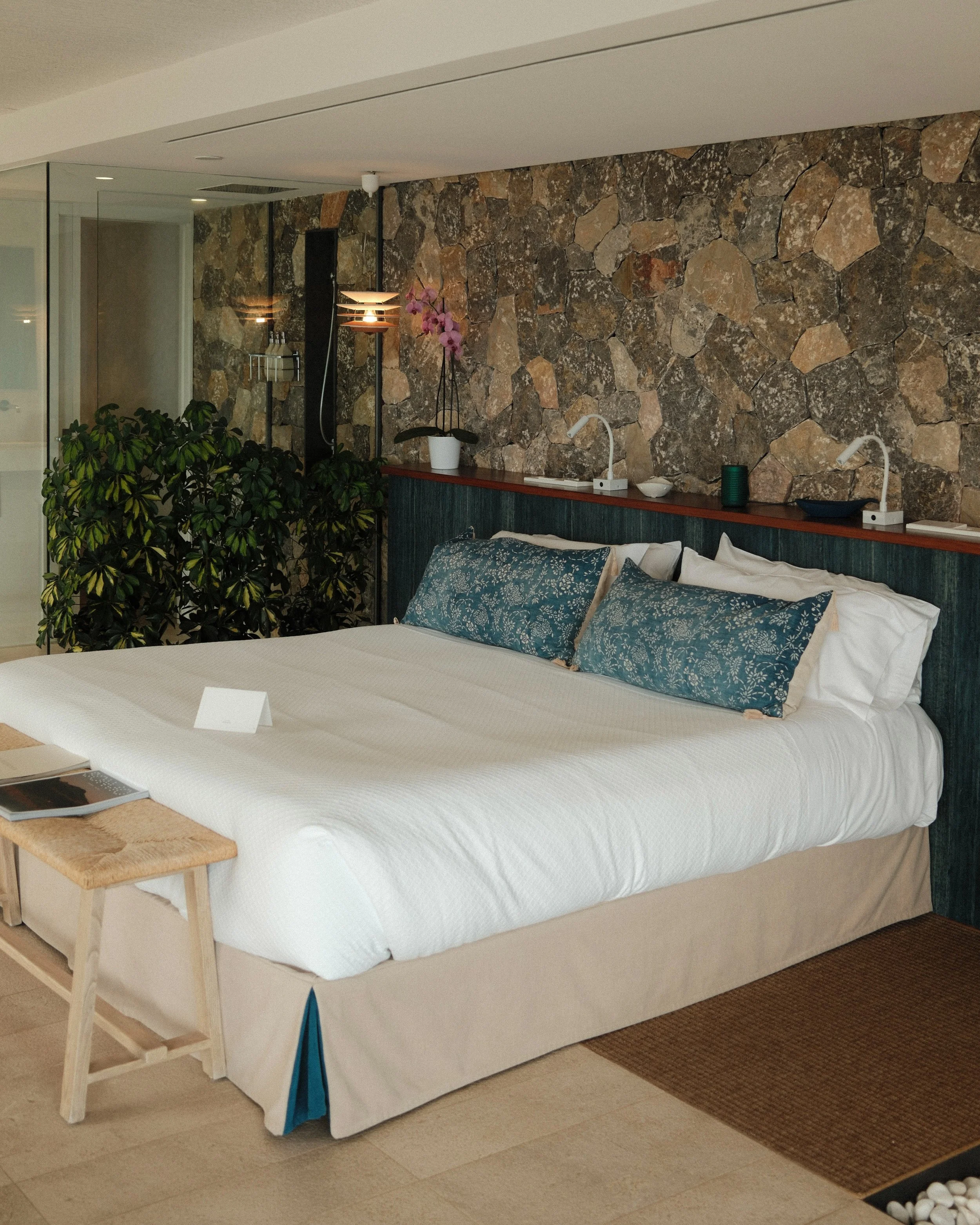 Spacious suite with natural stone walls, soft coastal tones and open-plan design at Sa Pedrissa, Deià, Mallorca