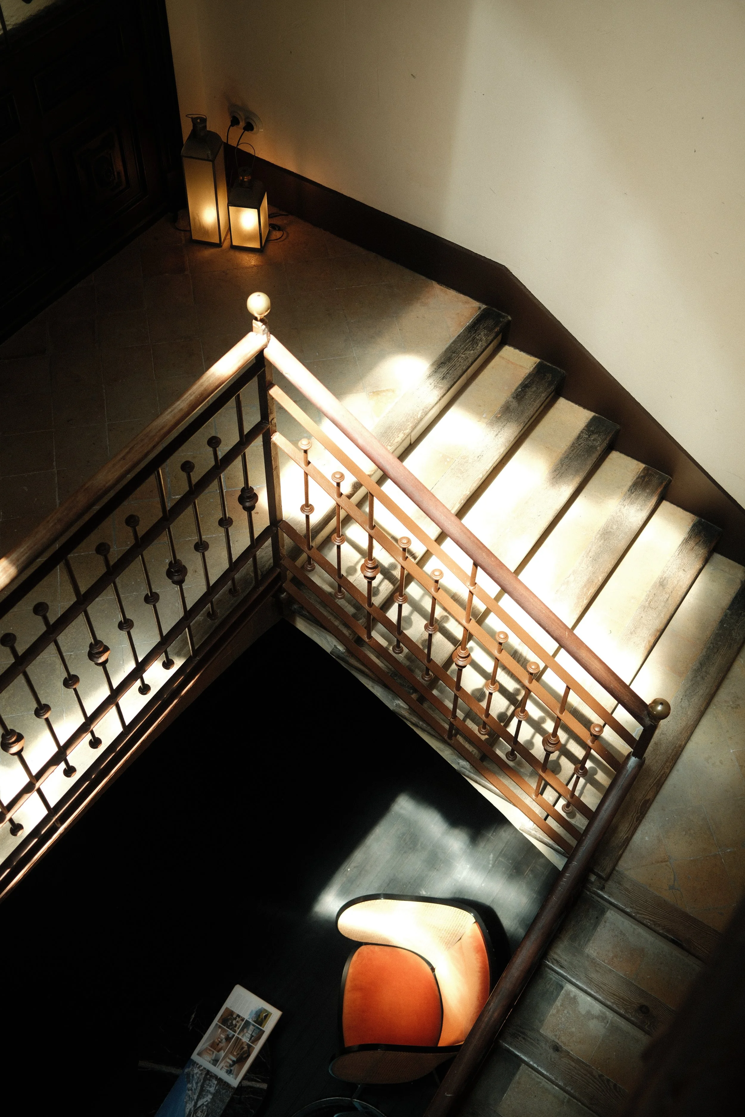 Historic staircase illuminated by natural light inside Can Bordoy Grand House & Garden
