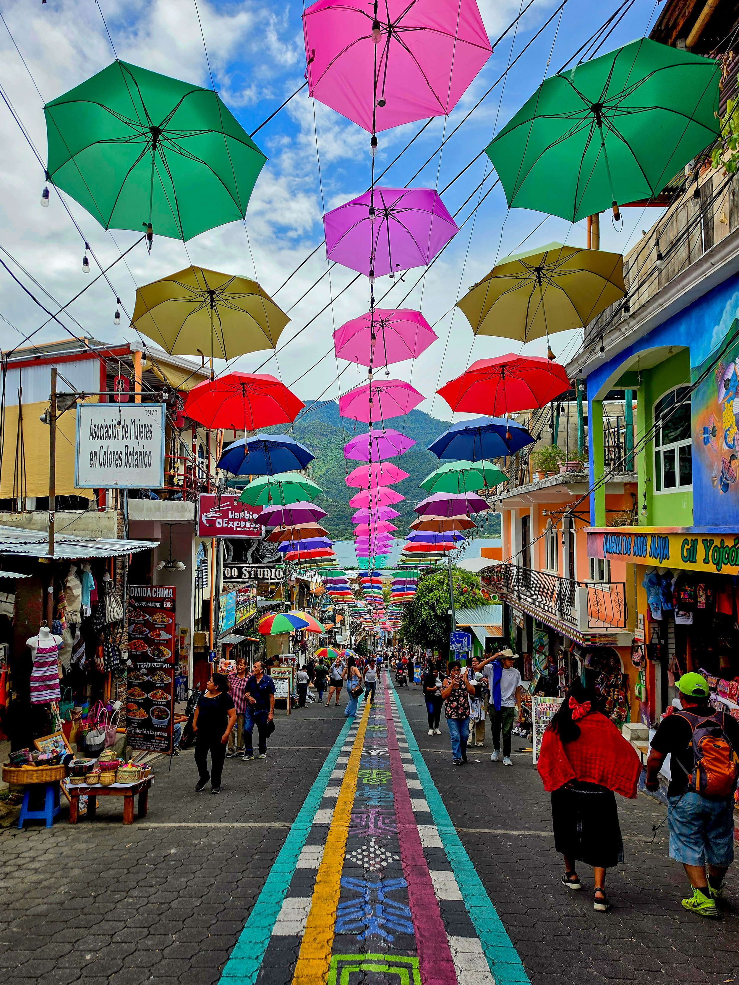 Colorful umbrella-lined street in San Marcos La Laguna overlooking Lake Atitlán