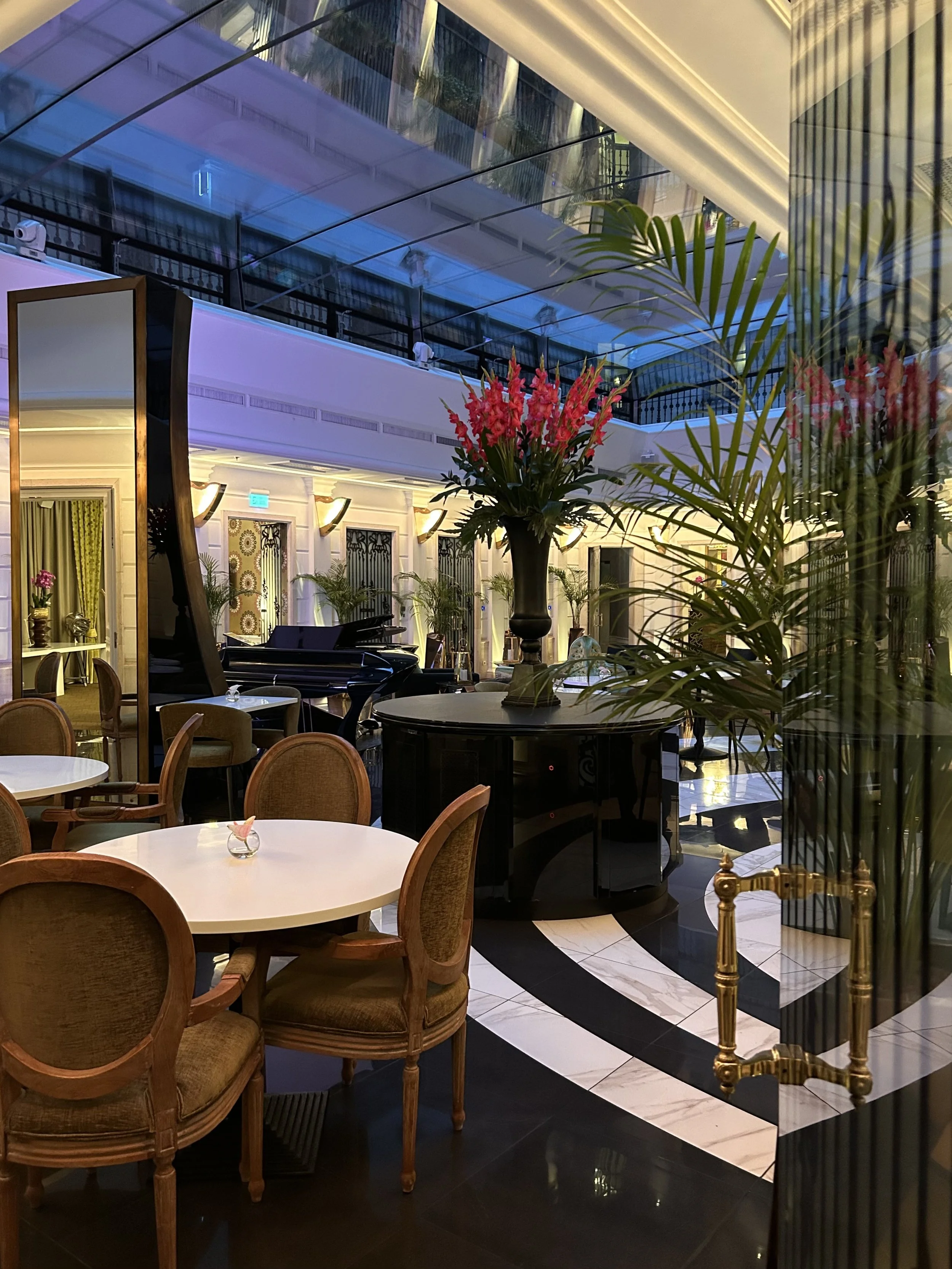 Elegant Music Garden lounge with grand piano and floral displays