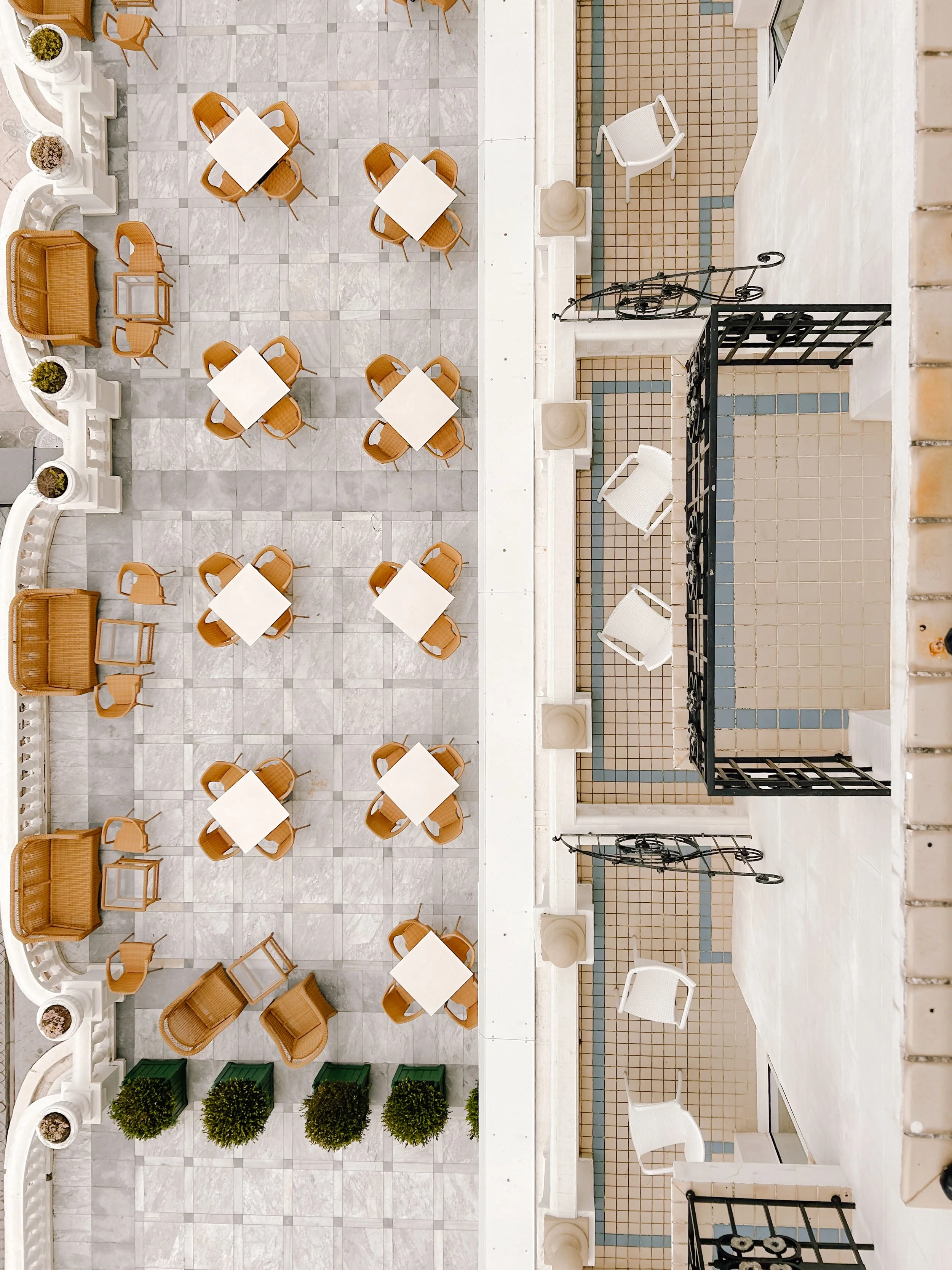 Symmetrical courtyard terrace viewed from above with marble flooring and outdoor seating