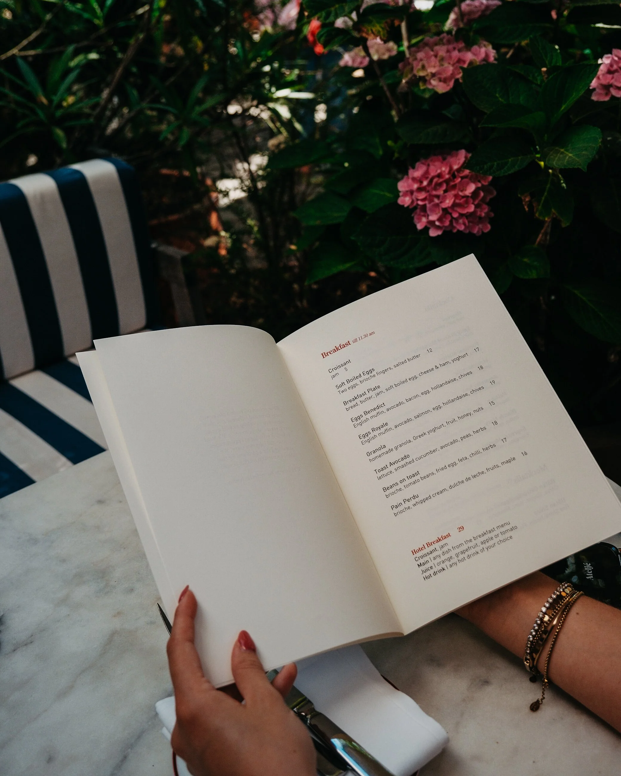 Breakfast menu enjoyed on the outdoor terrace surrounded by colourful flowers and greenery