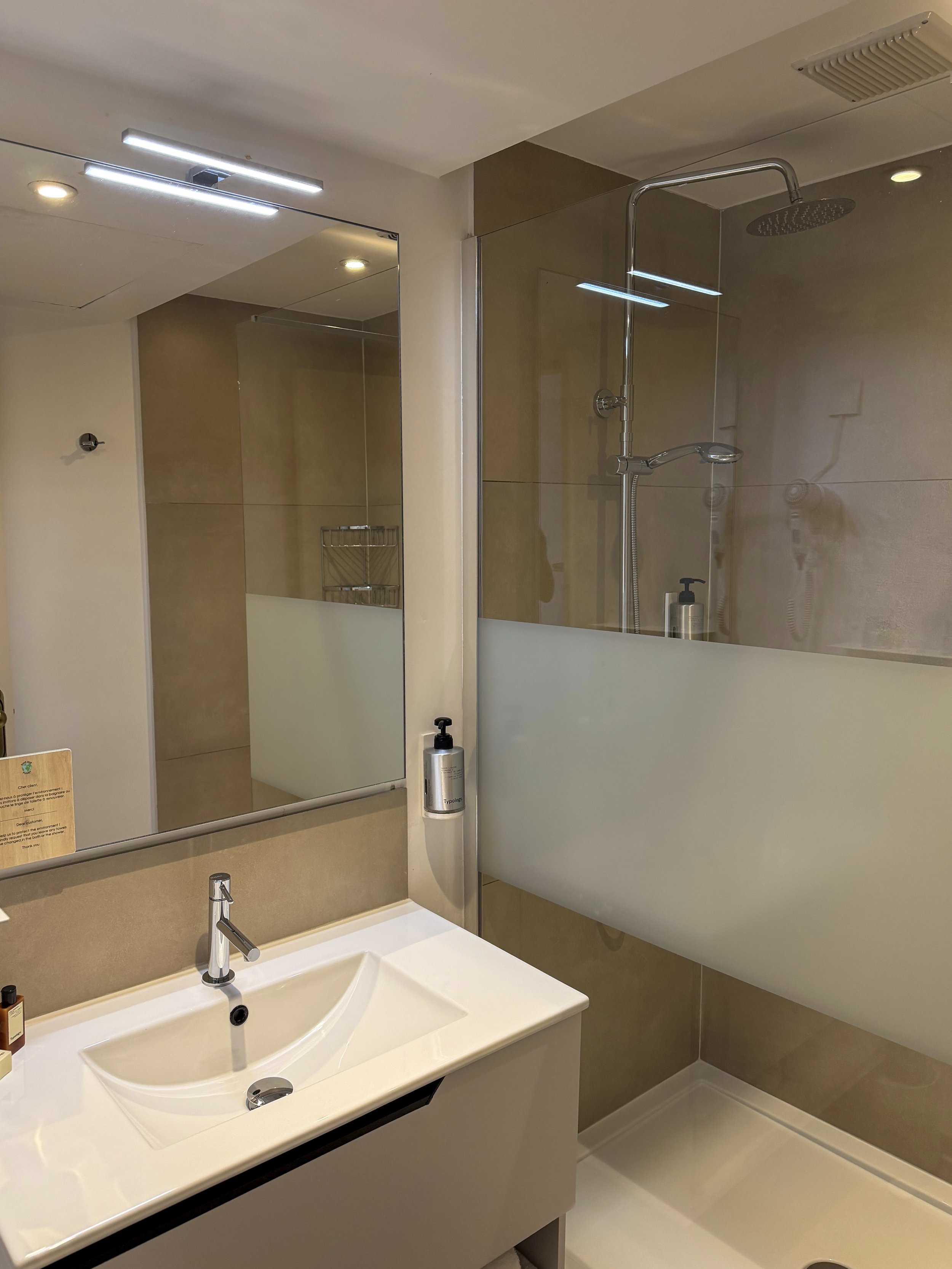 Minimalist bathroom featuring a spacious walk in rainfall shower