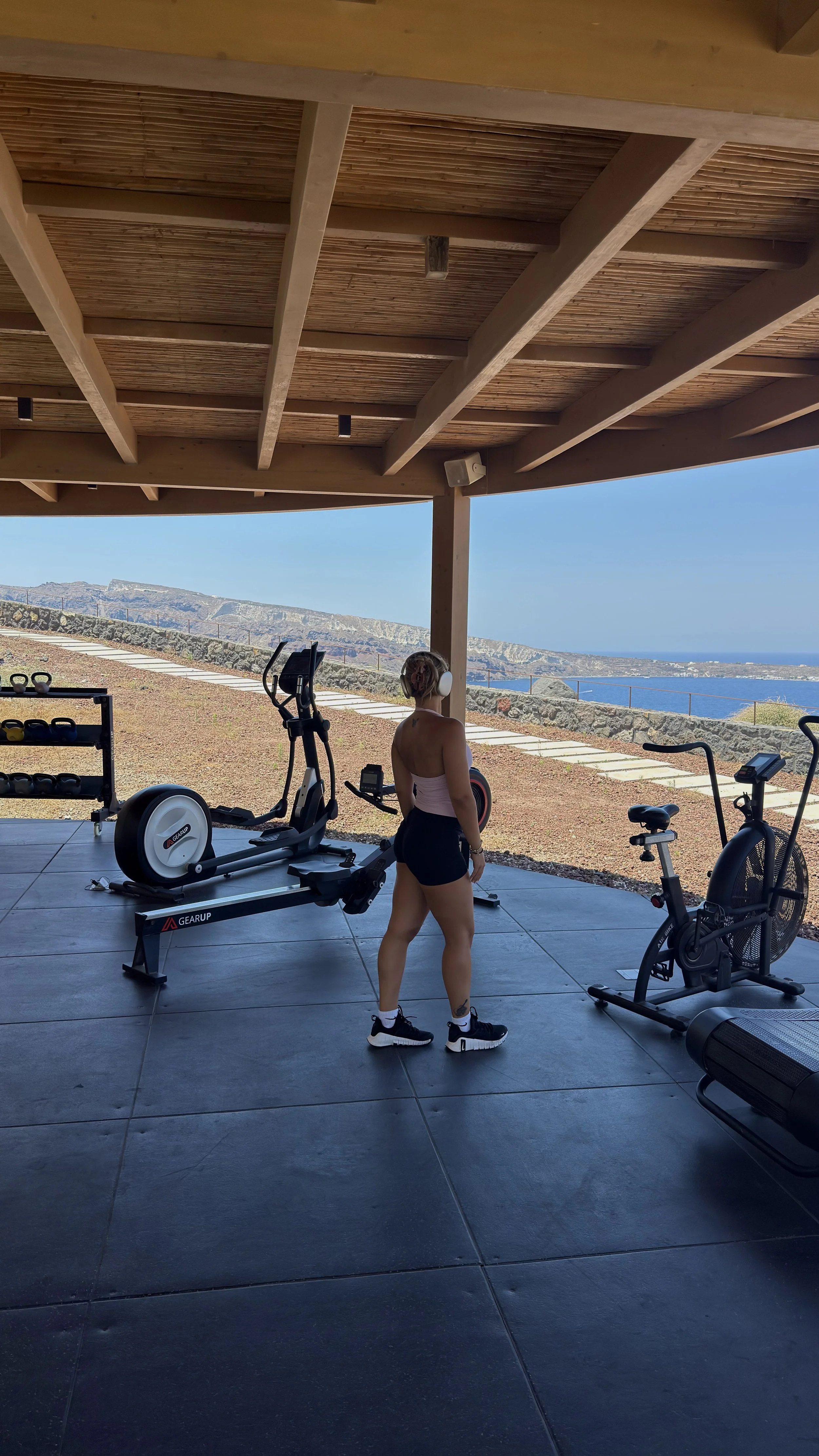 Outdoor fitness area combining luxury wellness facilities with spectacular caldera and sea views
