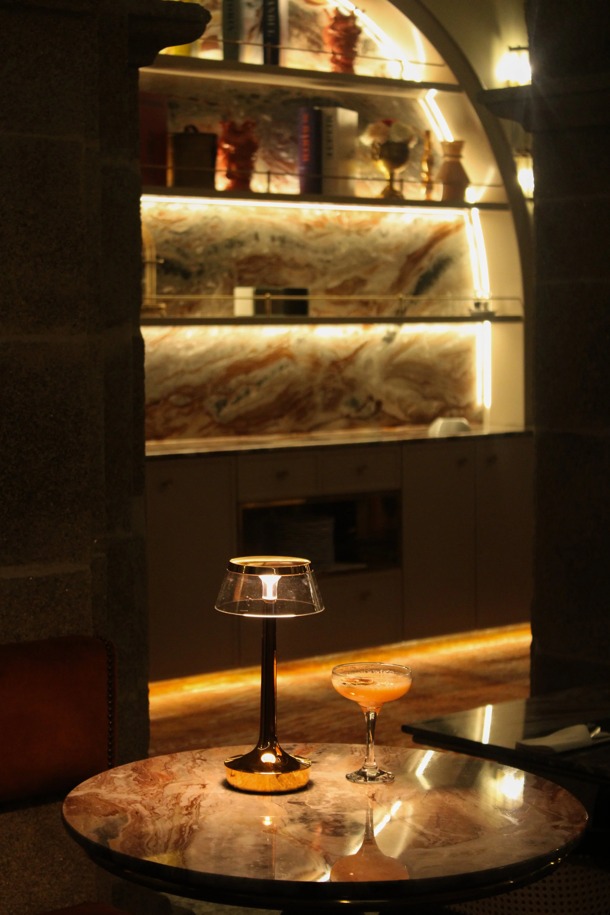 Intimate cocktail corner with marble textures and warm lighting at Convento do Seixo, Portugal
