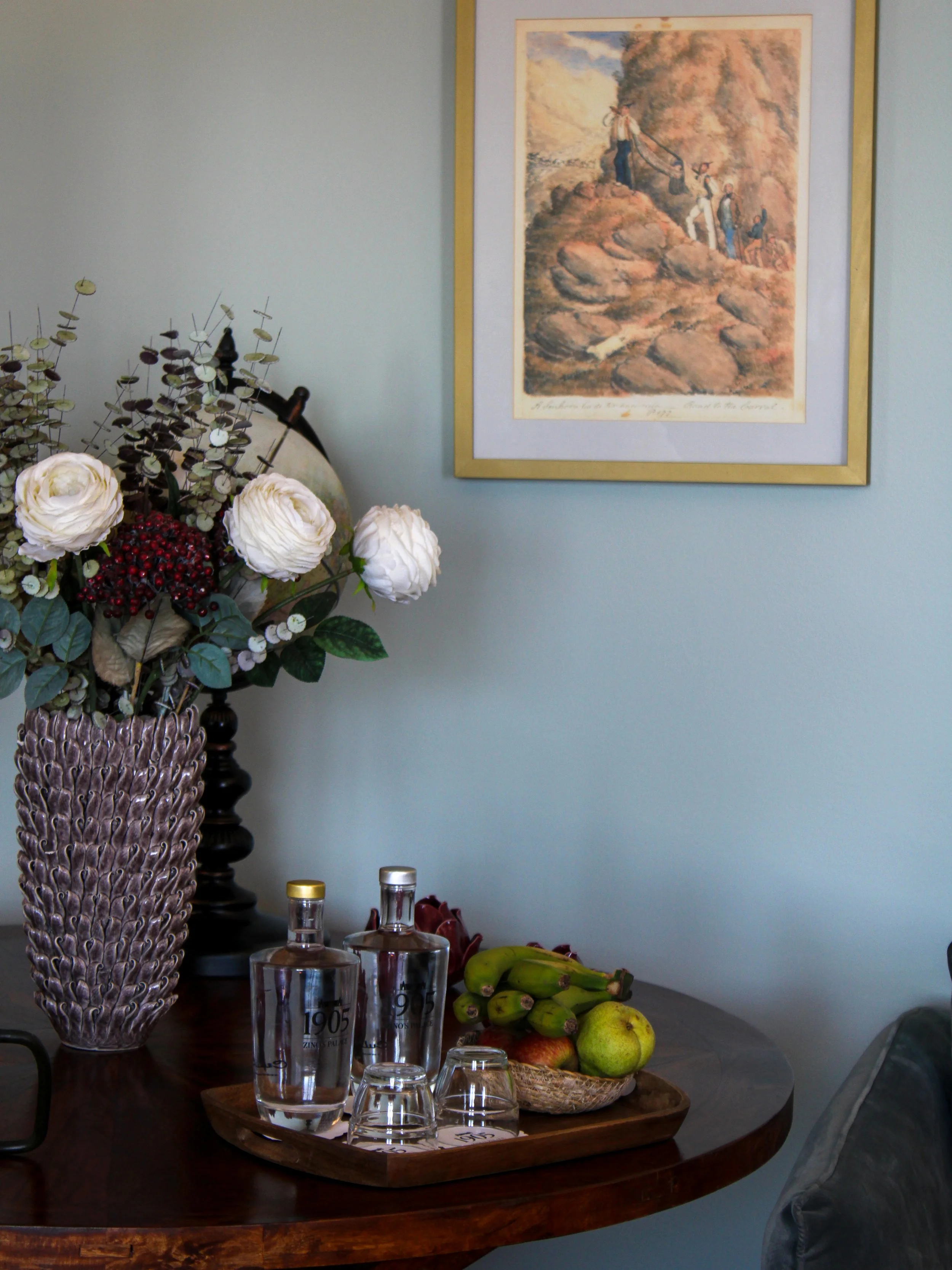 In-room welcome arrangement with fresh fruit, premium water, and refined decorative details