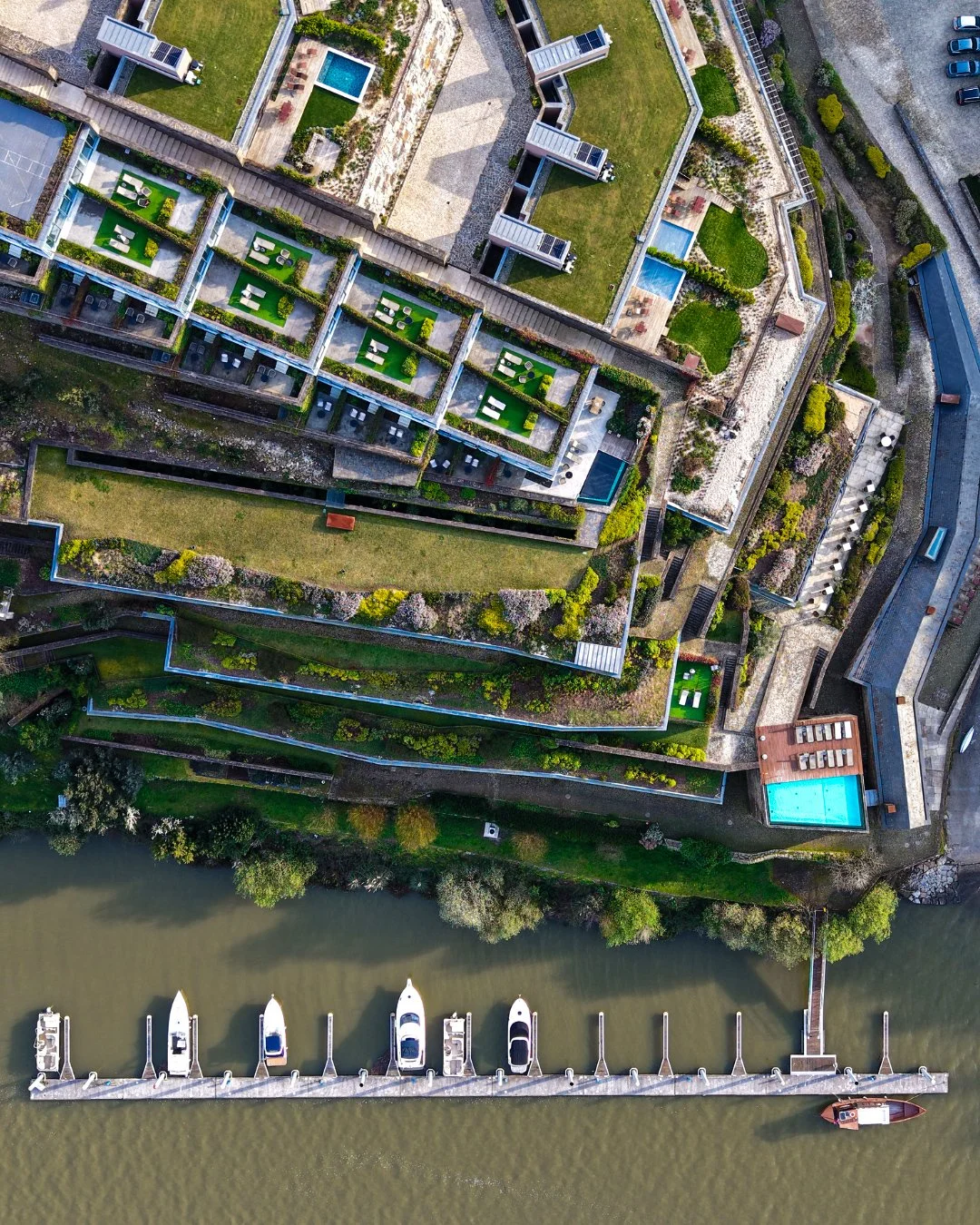 Aerial view of Octant Douro showcasing terraced architecture, private marina, and landscaped riverside gardens