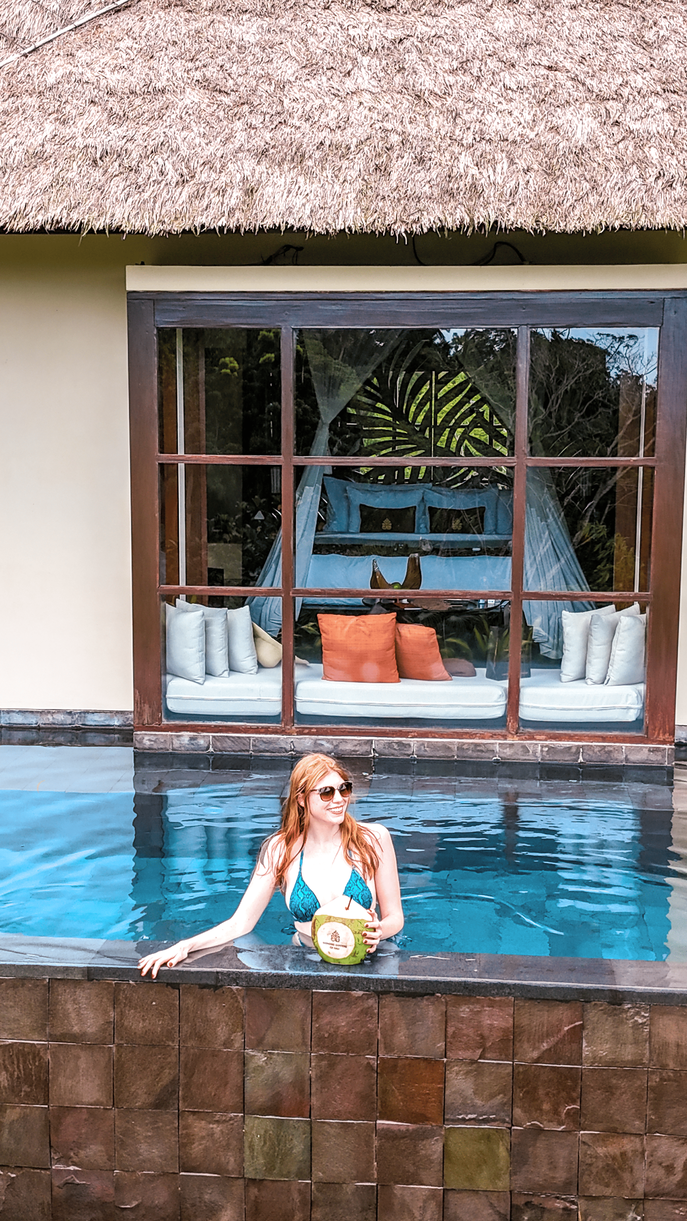 Guest relaxing in private pool with villa view at Hanging Gardens of Bali