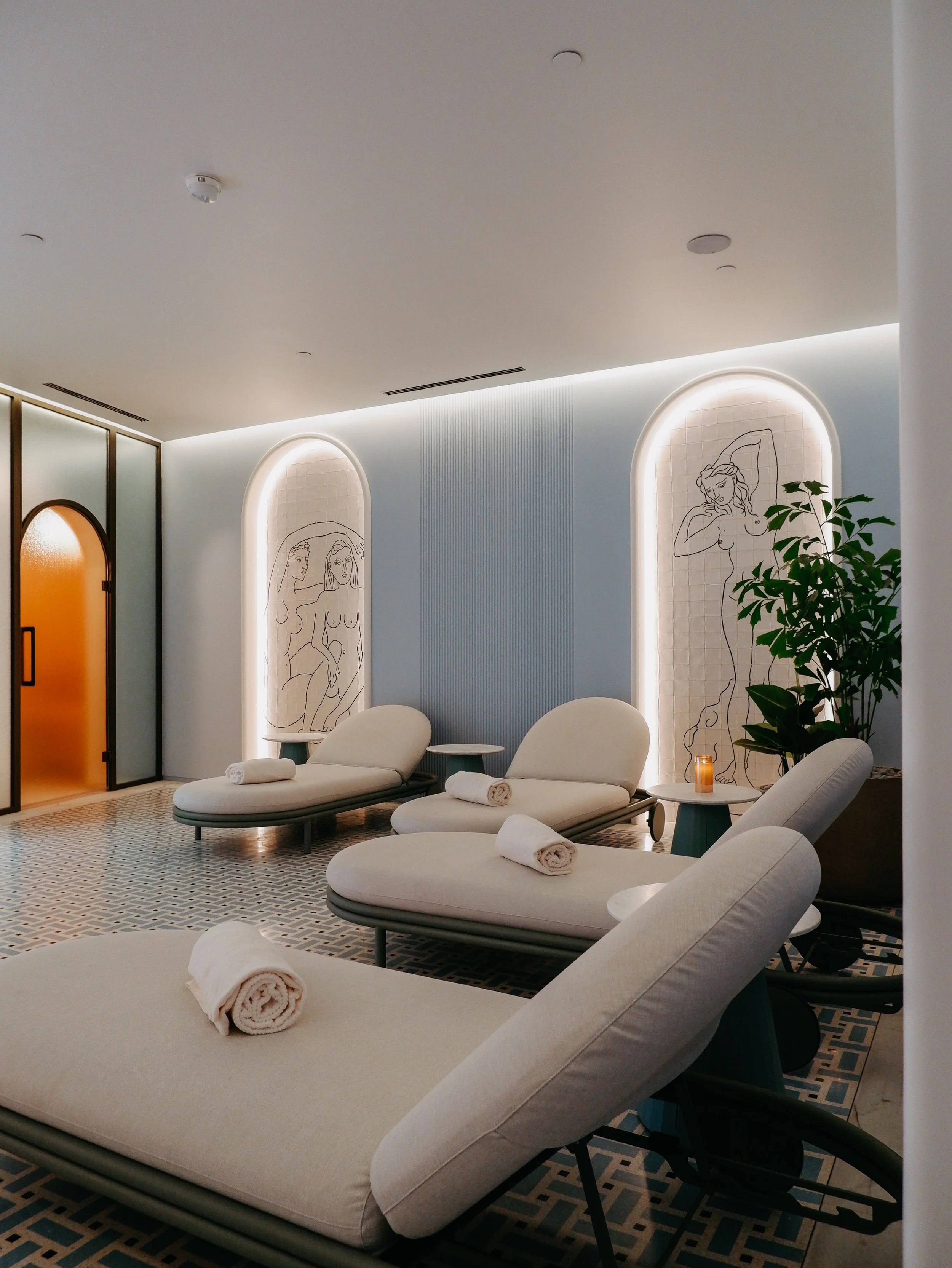 Serene spa relaxation lounge with contemporary loungers and ambient lighting