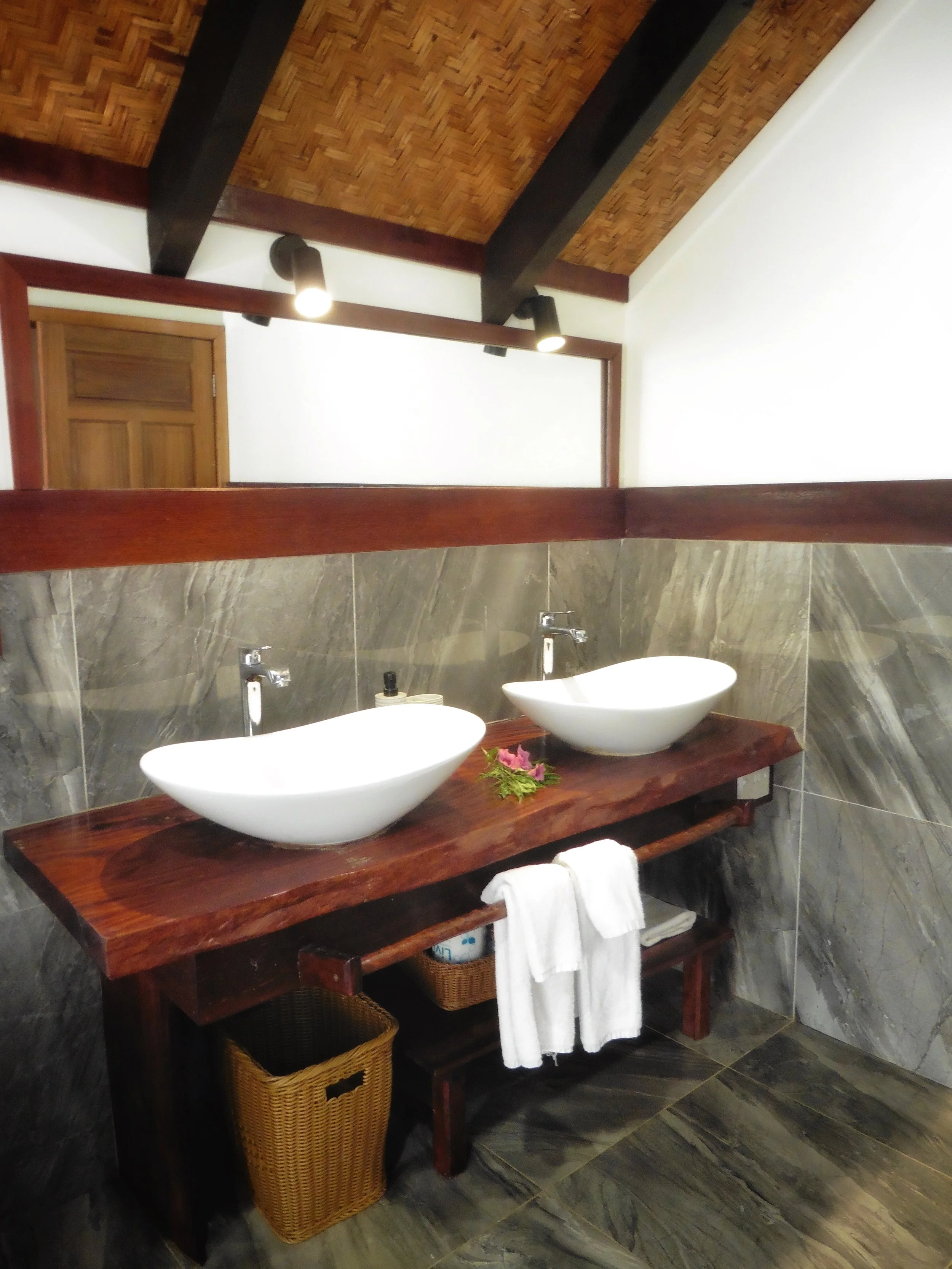 Tropical-style bathroom with natural wood finishes at Tamanu Beach Resort, Cook Islands