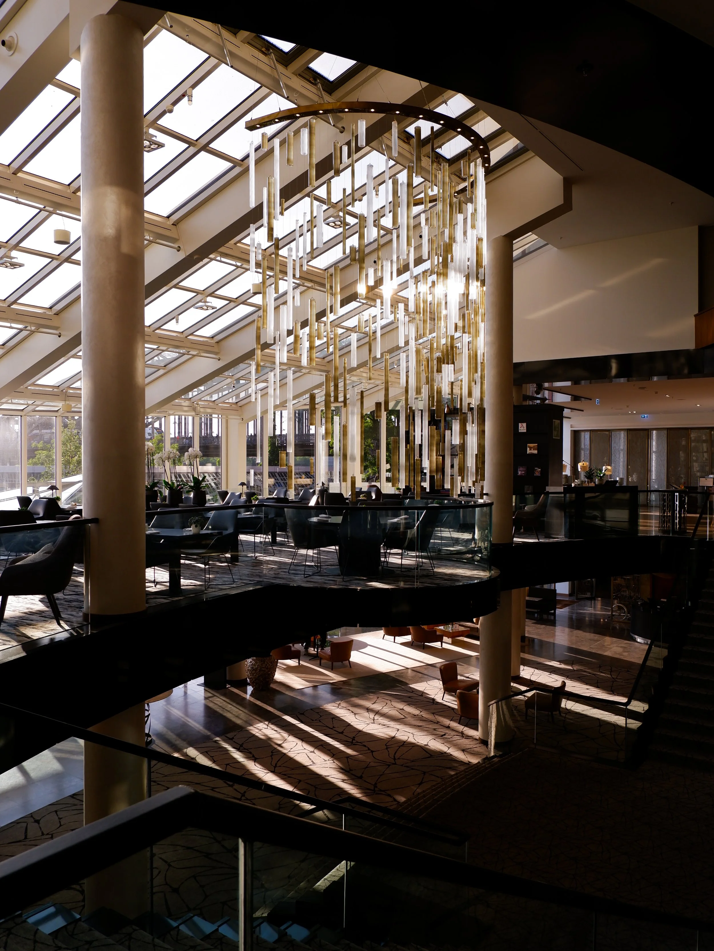 Grand hotel atrium featuring striking contemporary chandeliers and elegant open-plan architecture