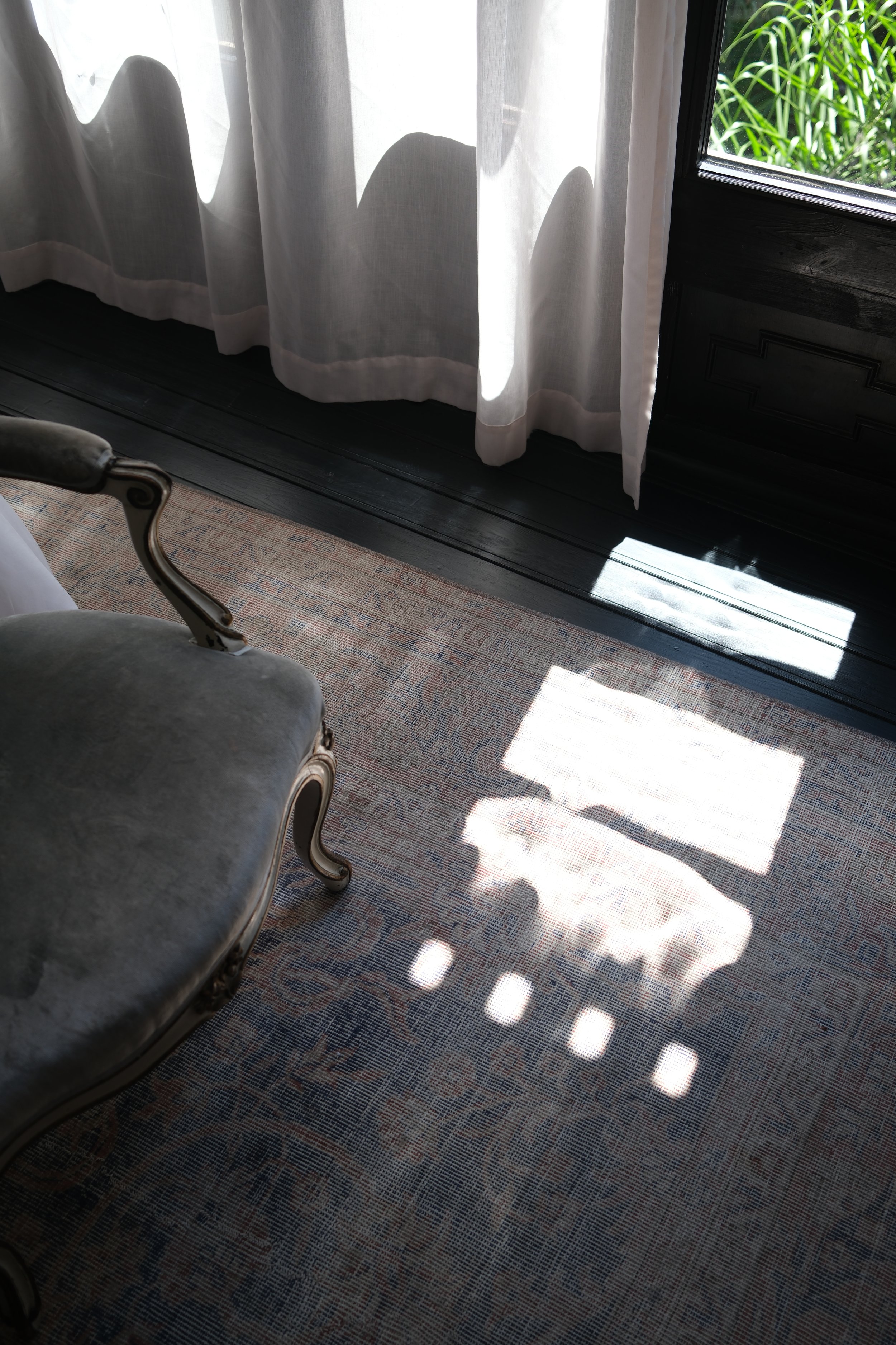 Morning light filtering through linen curtains inside Can Bordoy Grand House & Garden