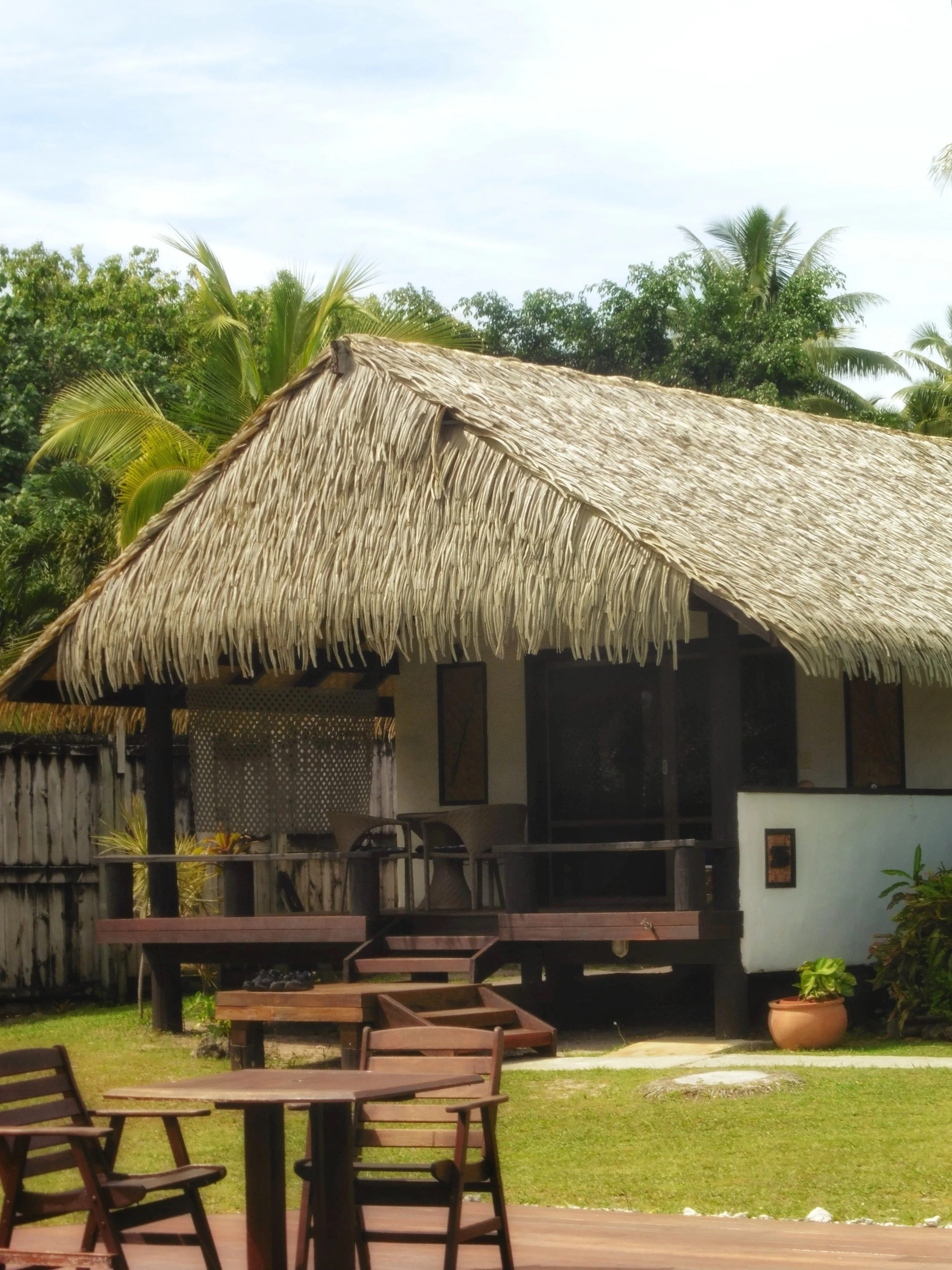 Traditional bungalow with thatched roof at Tamanu Beach Resort in the Cook Islands