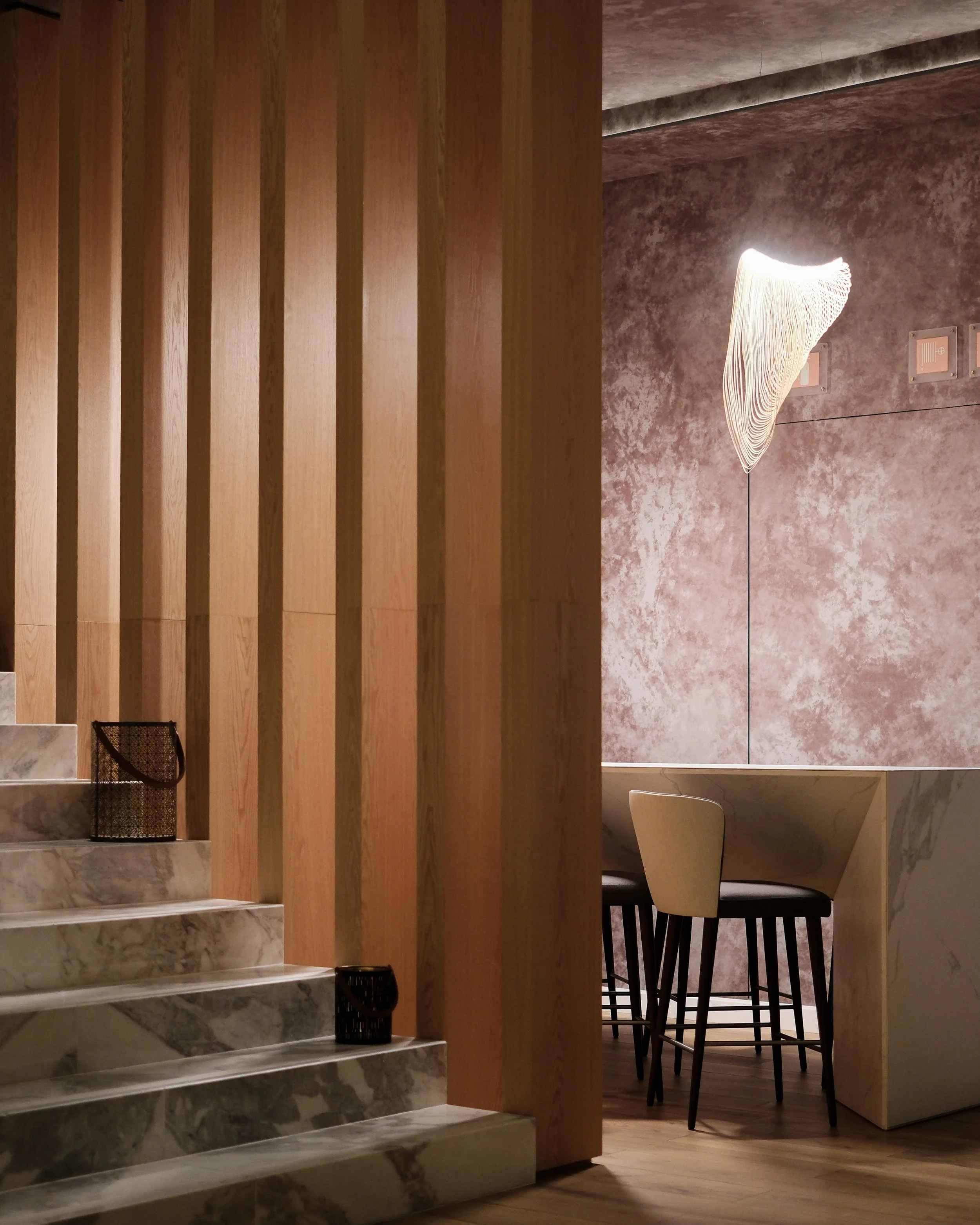 Modern interior showcasing warm wood finishes, marble details, and refined contemporary design