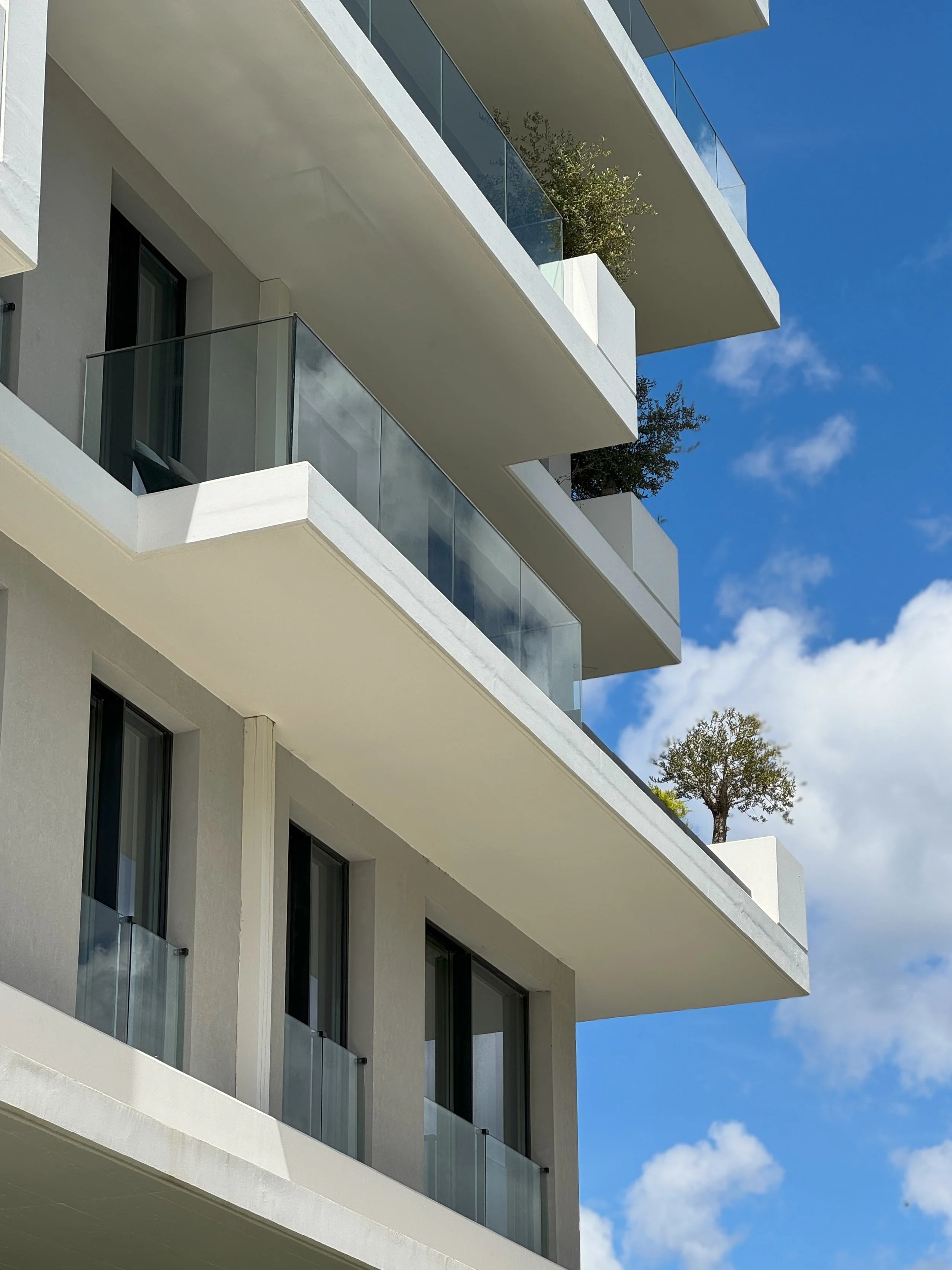 Architectural detail showcasing glass balconies and clean contemporary design