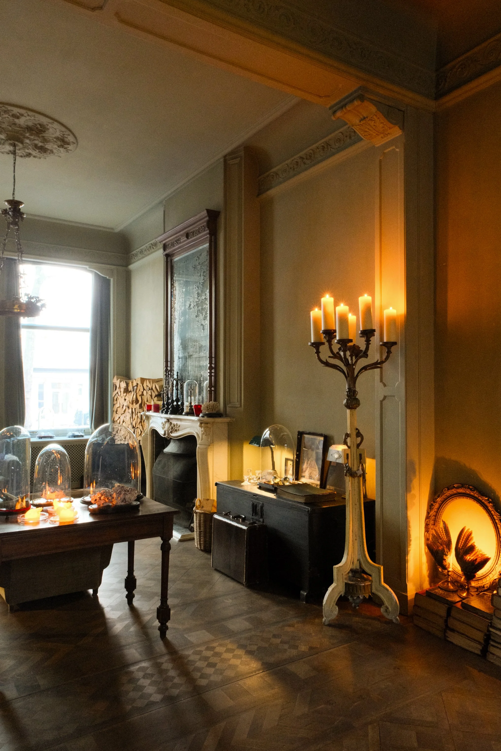 Elegant heritage lounge with fireplace, antiques, and candlelit ambiance