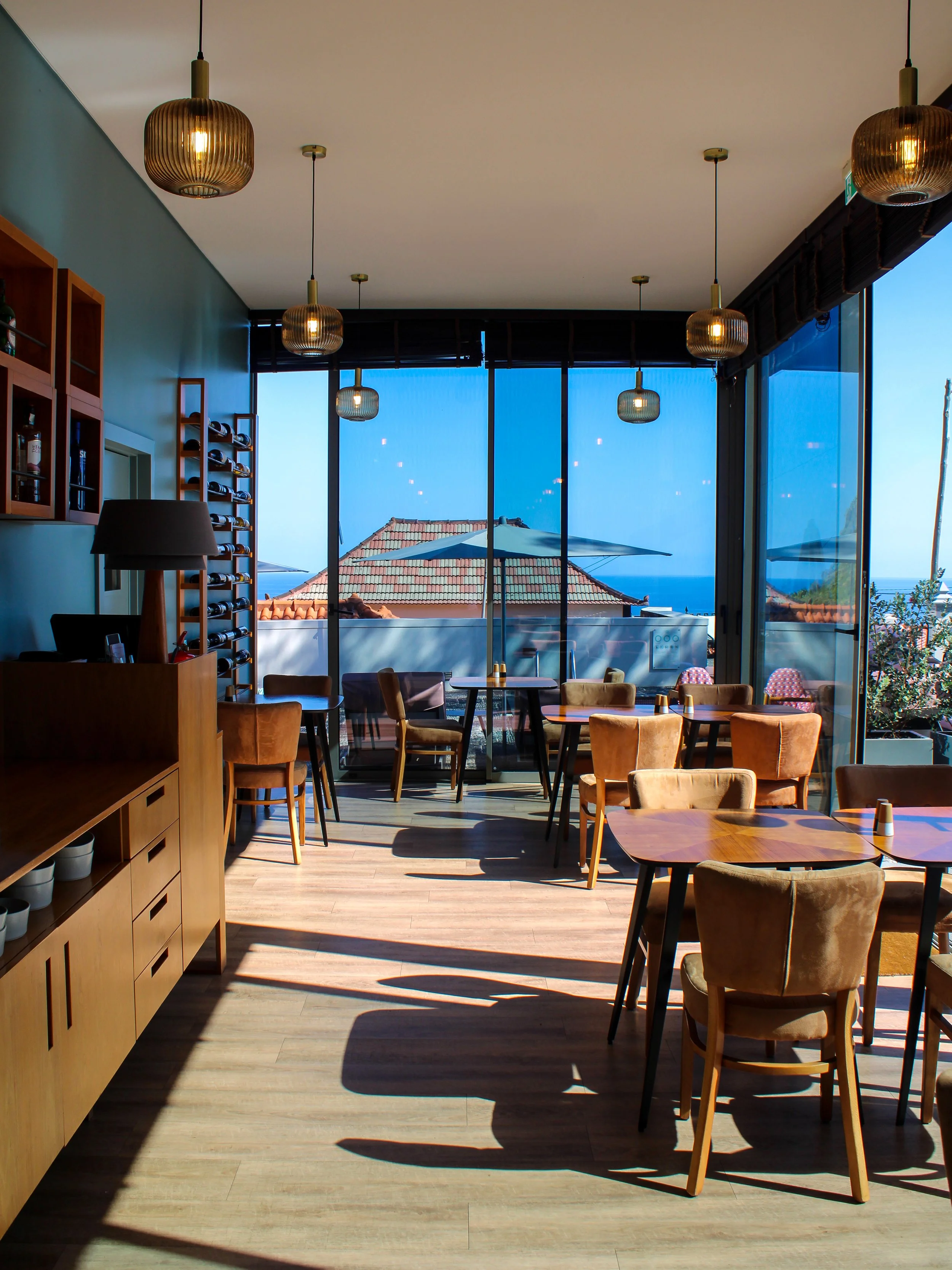Contemporary restaurant with ocean views, stylish interiors, and an inviting dining atmosphere