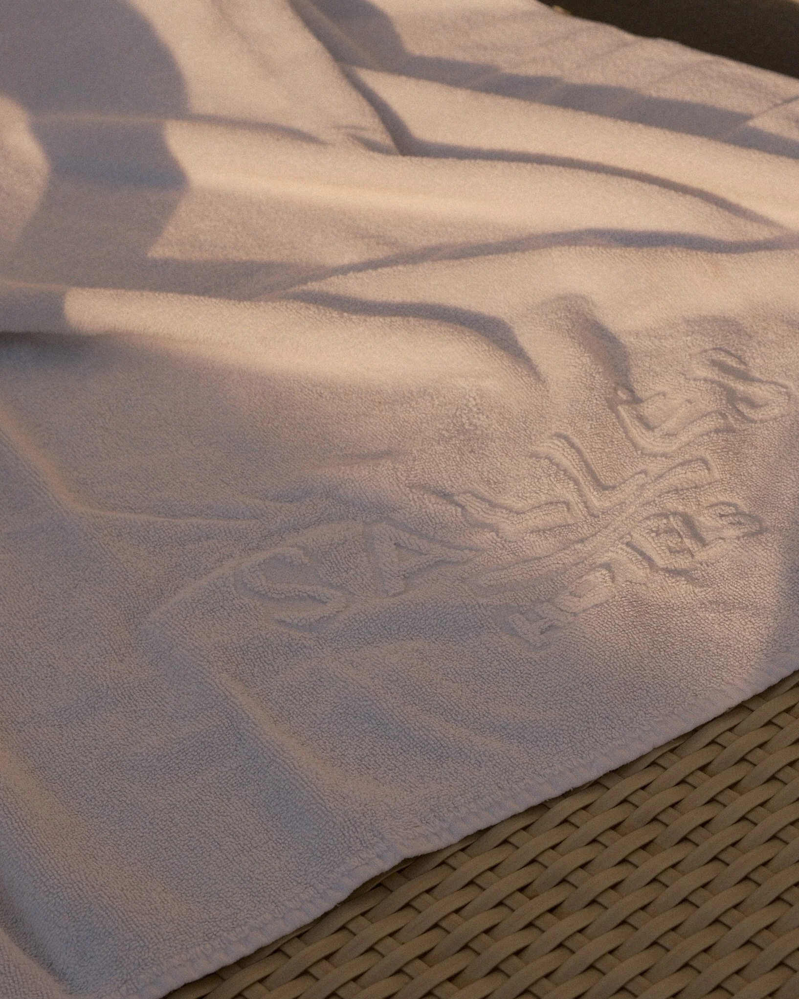 Luxury spa towel embroidered with the Sallés Hotels logo