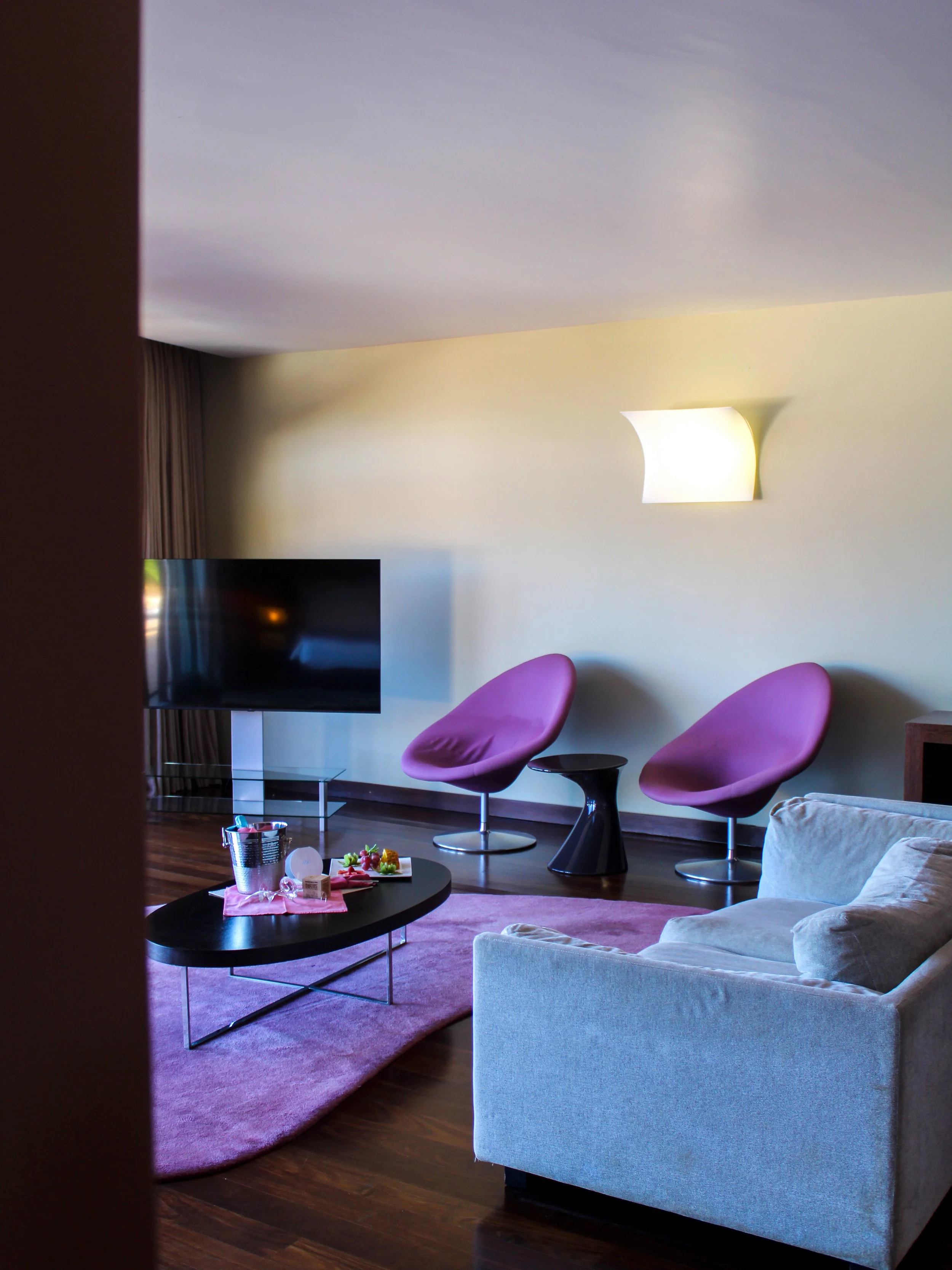 Spacious luxury suite with elegant lounge area, designer furnishings, and modern comforts