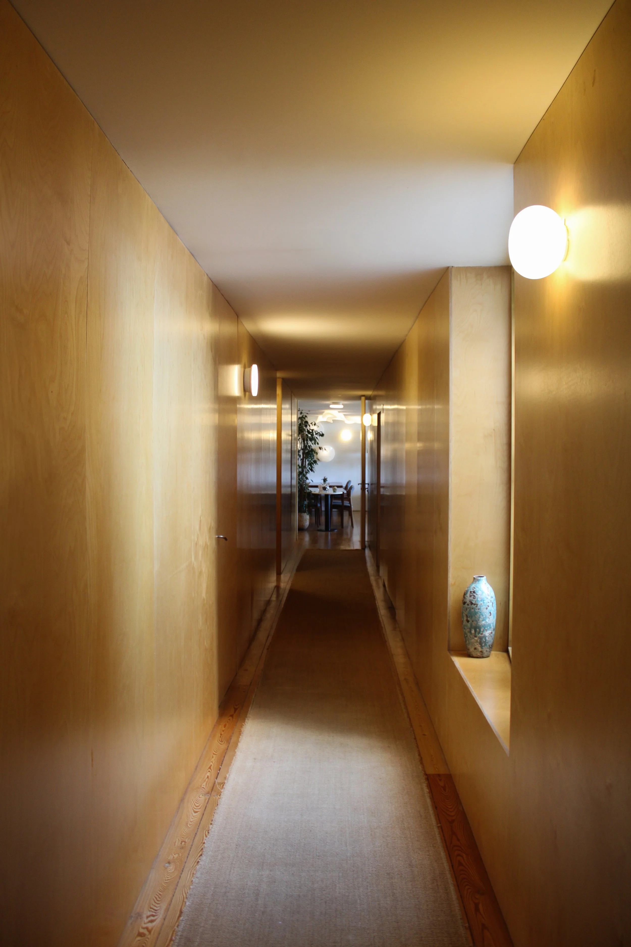 Minimalist wooden corridor with warm lighting and natural textures at Casas da Lapa in Serra da Estrela, Portugal