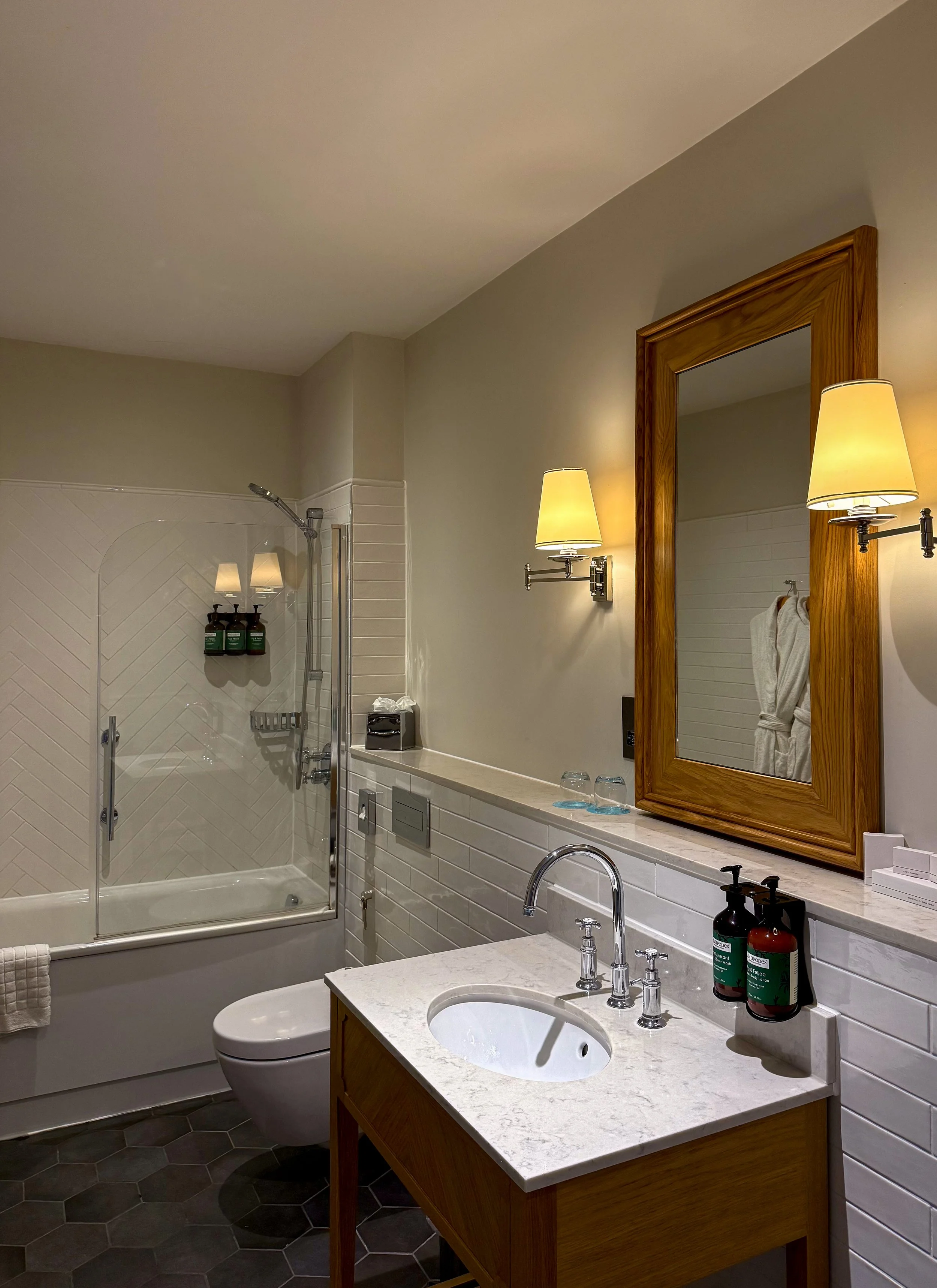 Bright marble bathroom with premium amenities and timeless English design