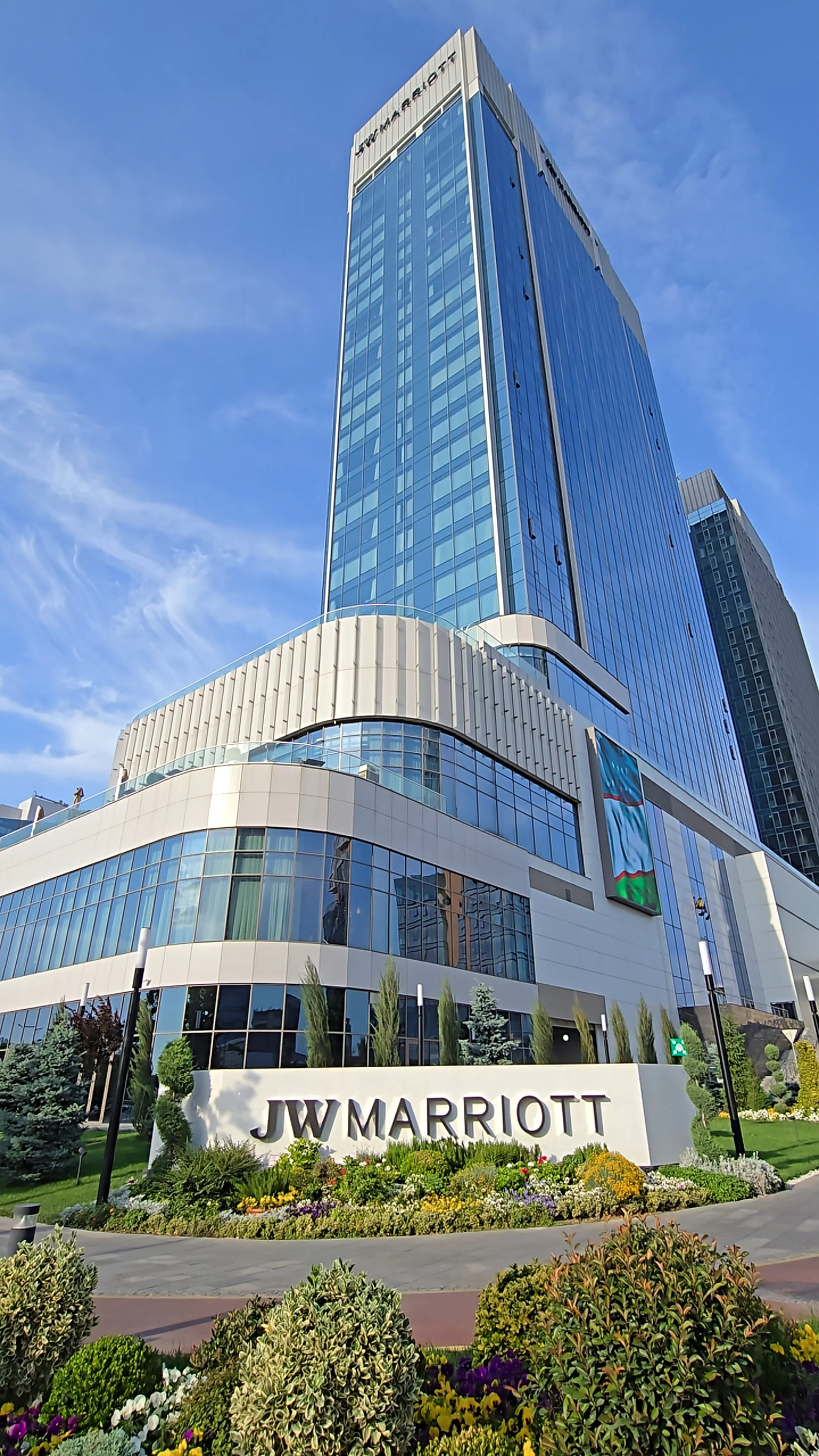 Contemporary glass façade showcasing the hotel’s striking modern architecture in central Tashkent