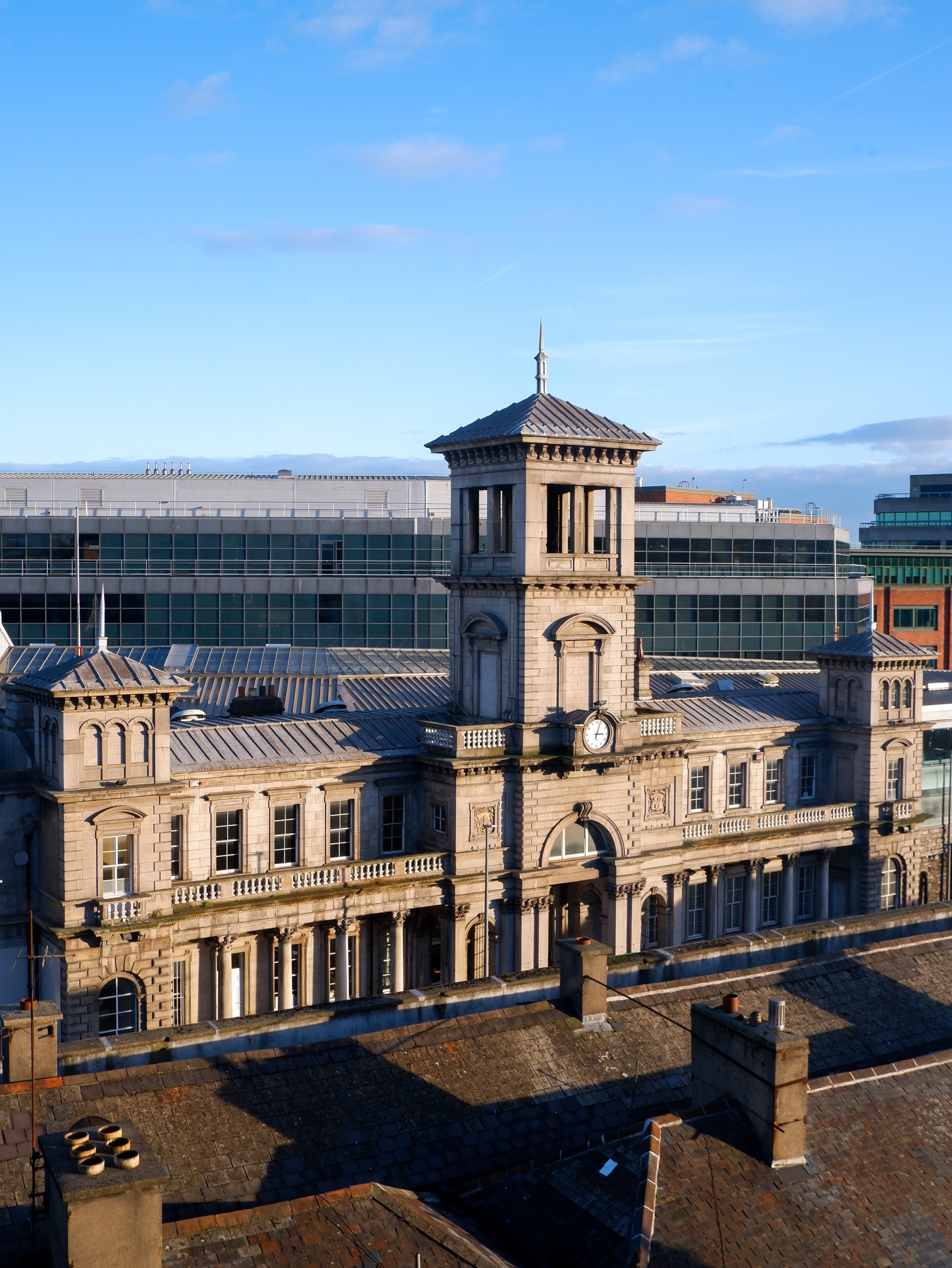 Historic Connolly Station building in Dublin featuring a central clock tower and elegant stone architecture