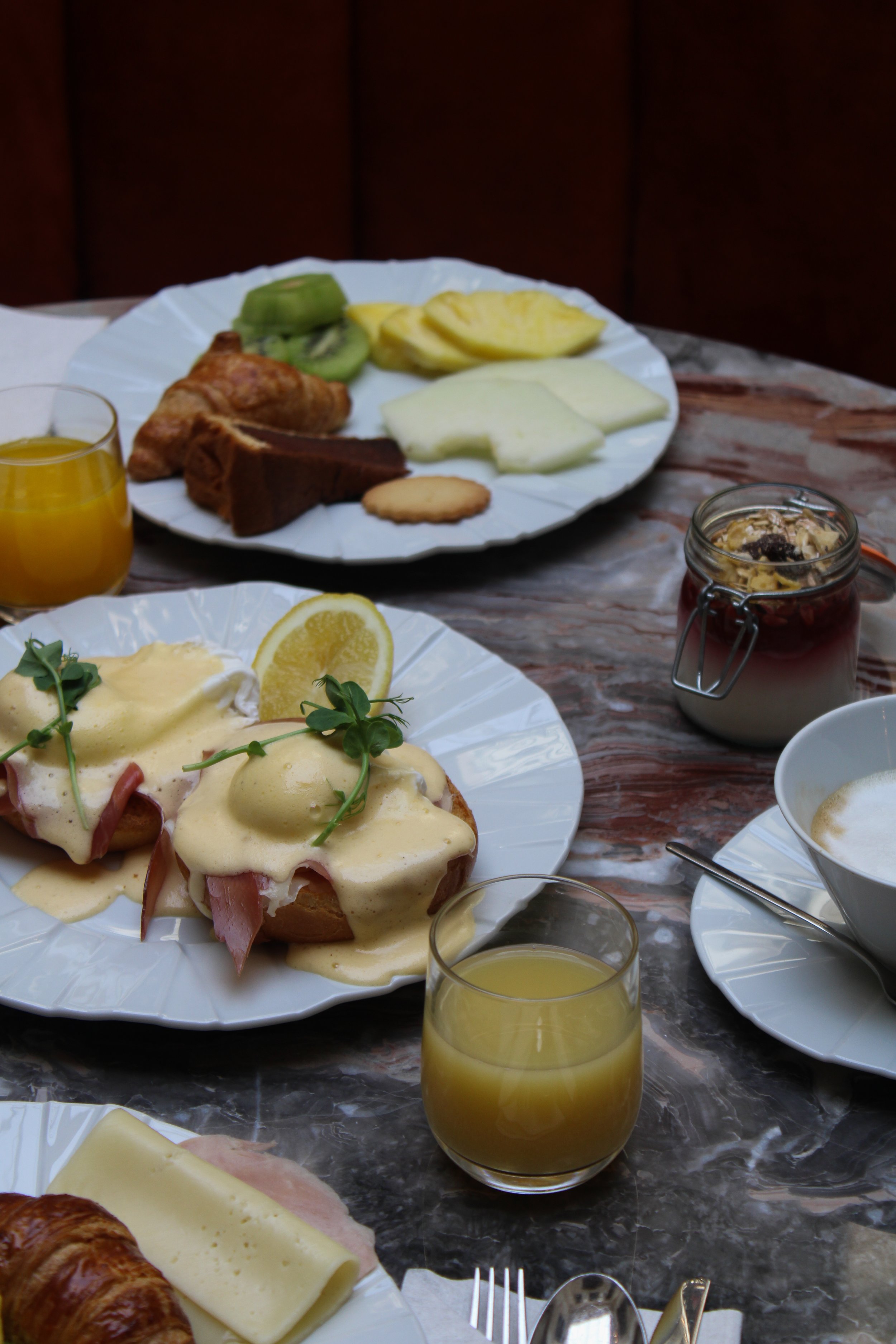Gourmet breakfast with Eggs Benedict, fresh pastries, seasonal fruit, and artisan coffee