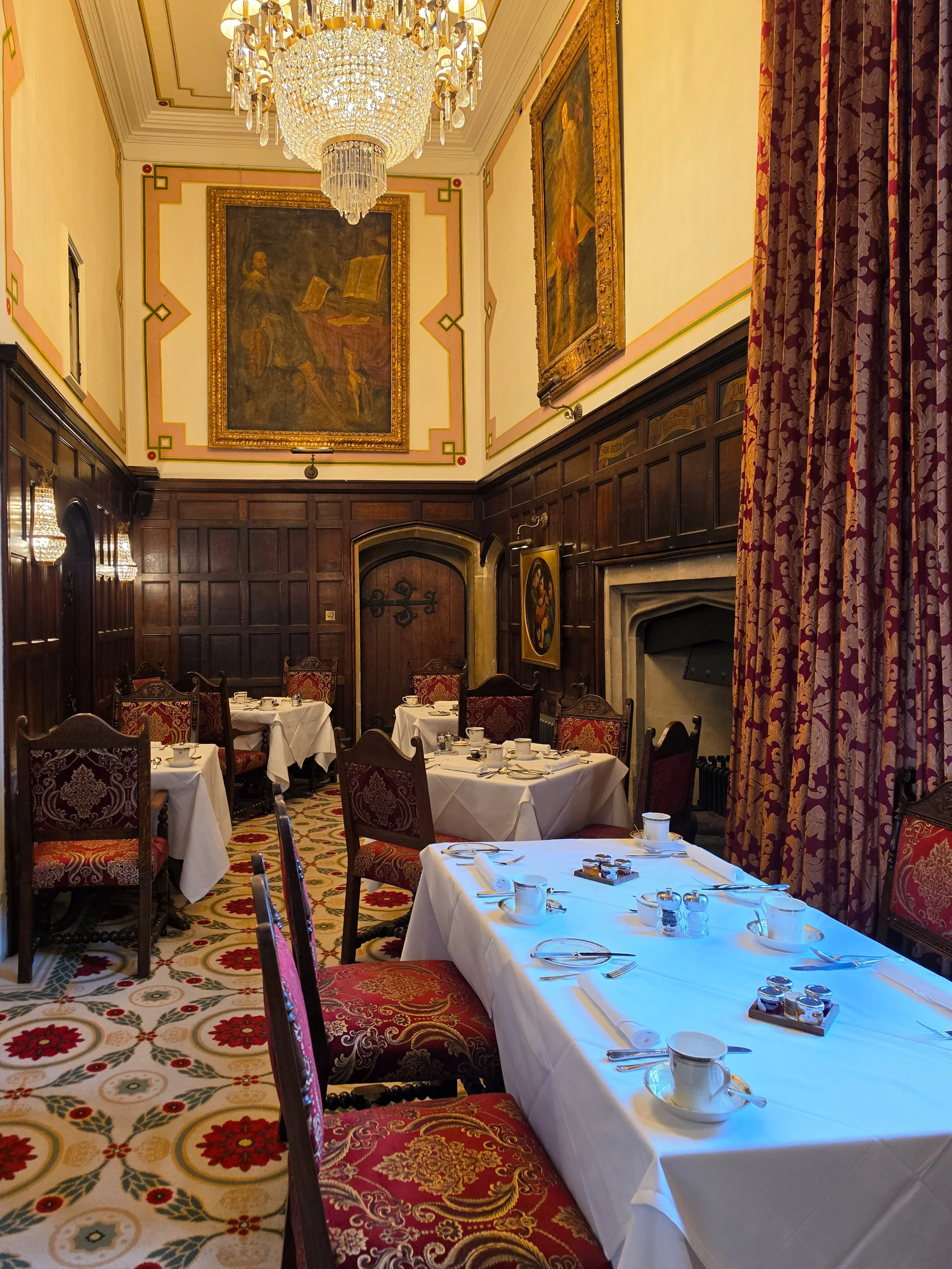 Historic breakfast room with Tudor décor, crystal chandeliers, and timeless English elegance