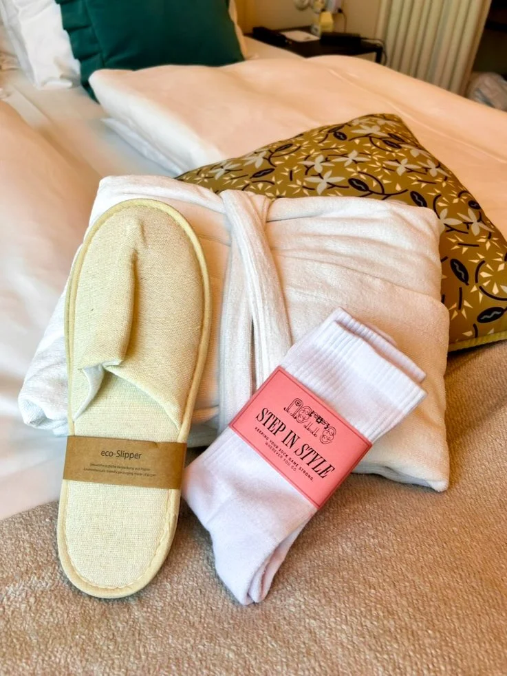 Thoughtful in-room amenities including slippers, bathrobe, and welcome touches