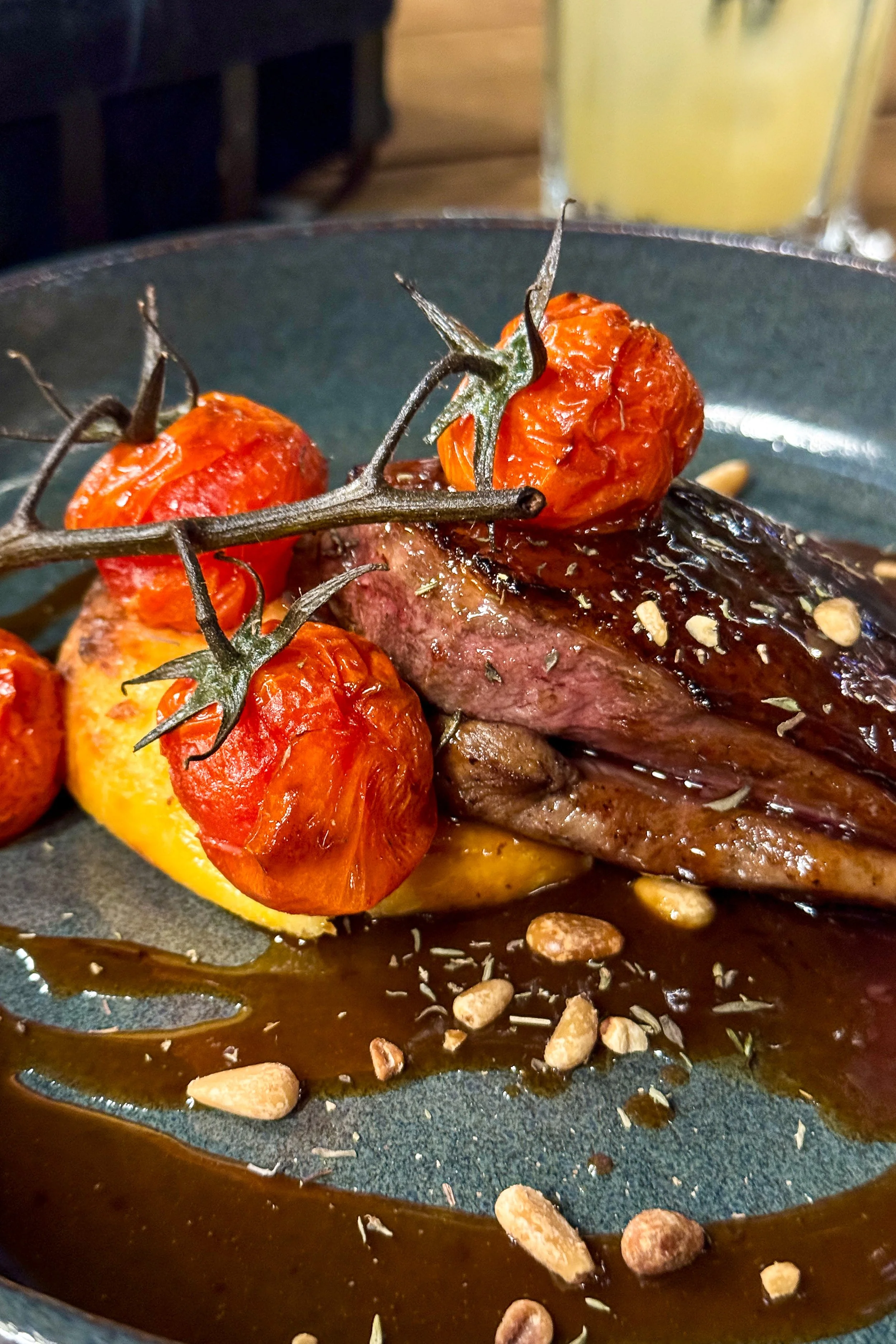 Perfectly cooked duck breast served with roasted tomatoes and rich jus