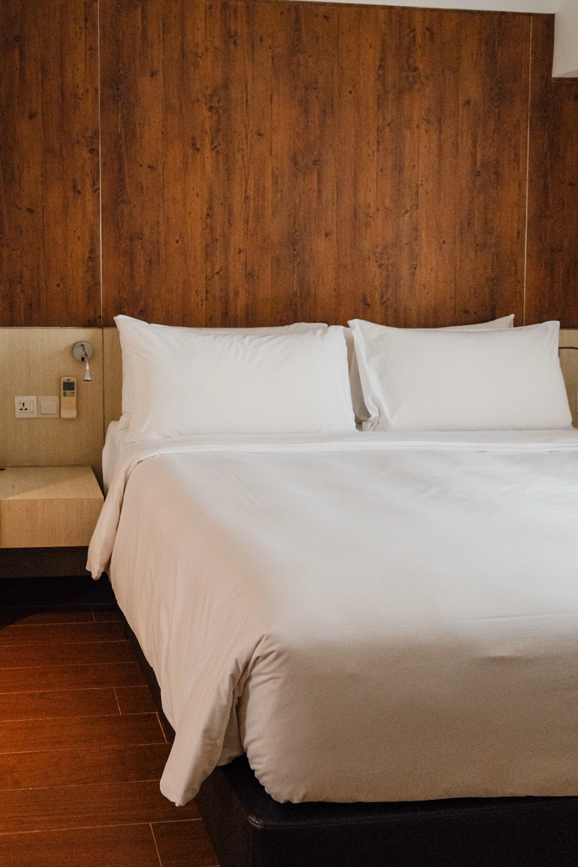 Comfortable bedroom designed with warm wood accents and modern furnishings