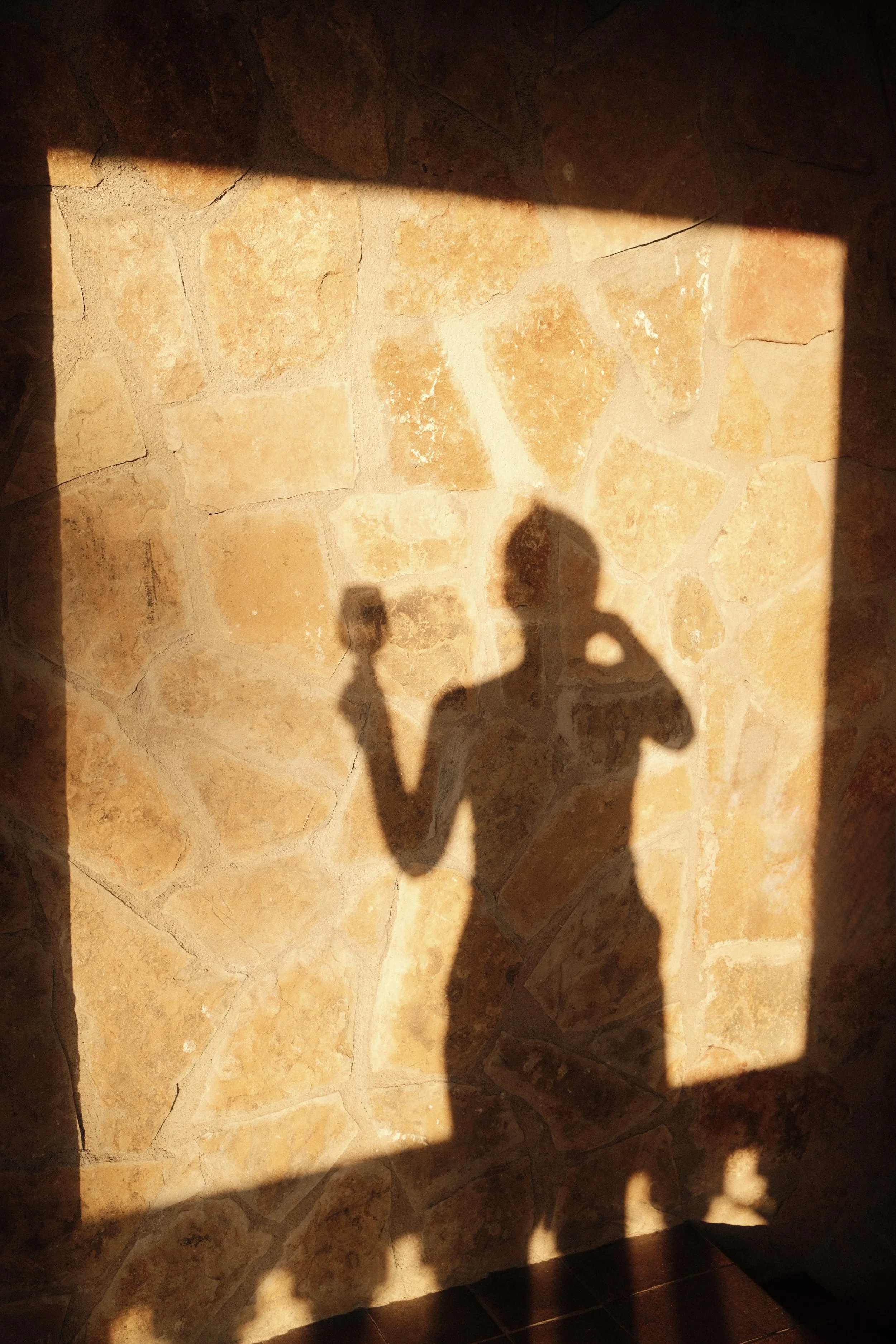 Golden hour shadows across rustic stone walls at Son Molí Country House in Mallorca