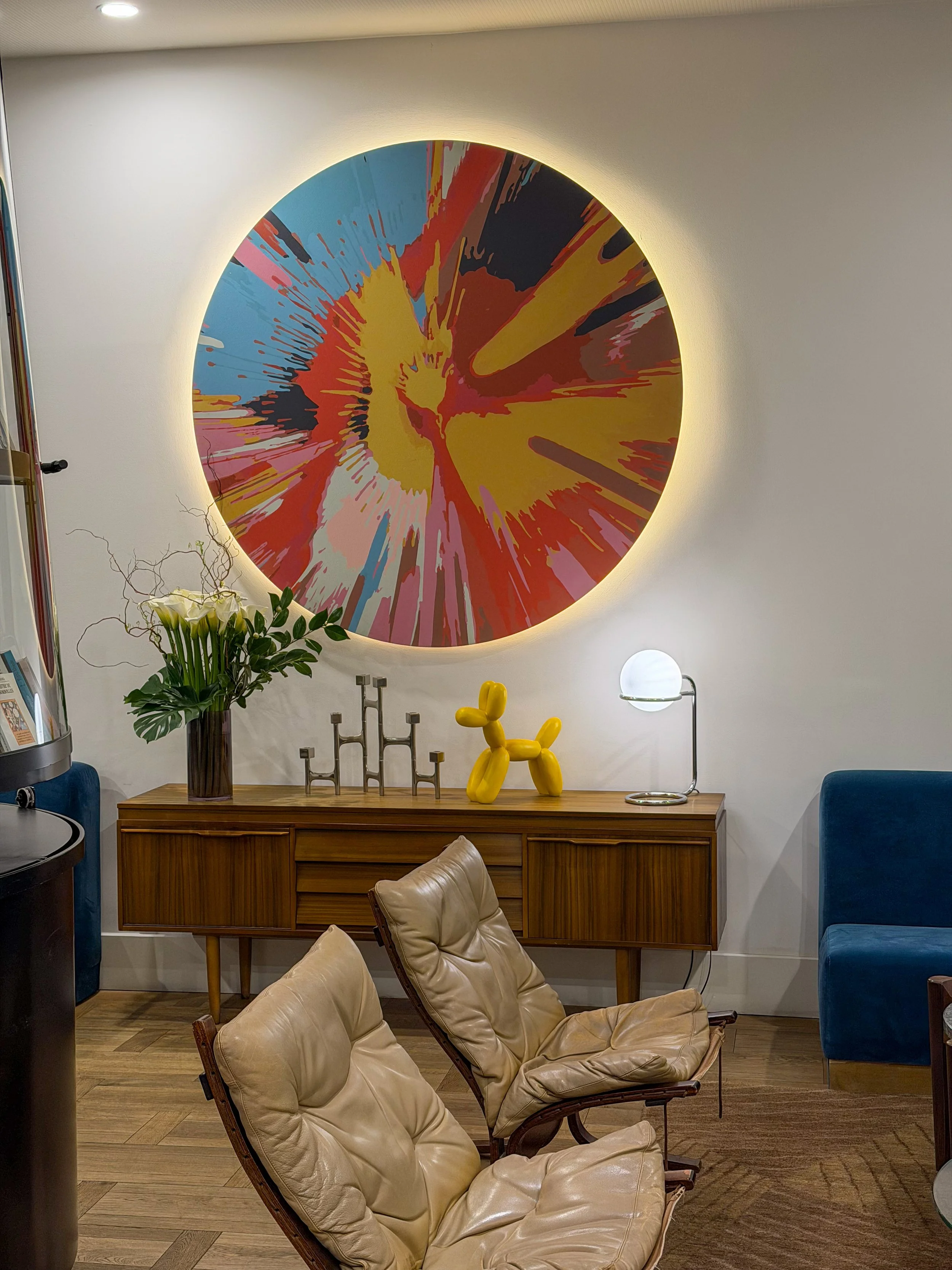 Stylish lounge blending contemporary furniture, bold artwork, and warm ambient lighting