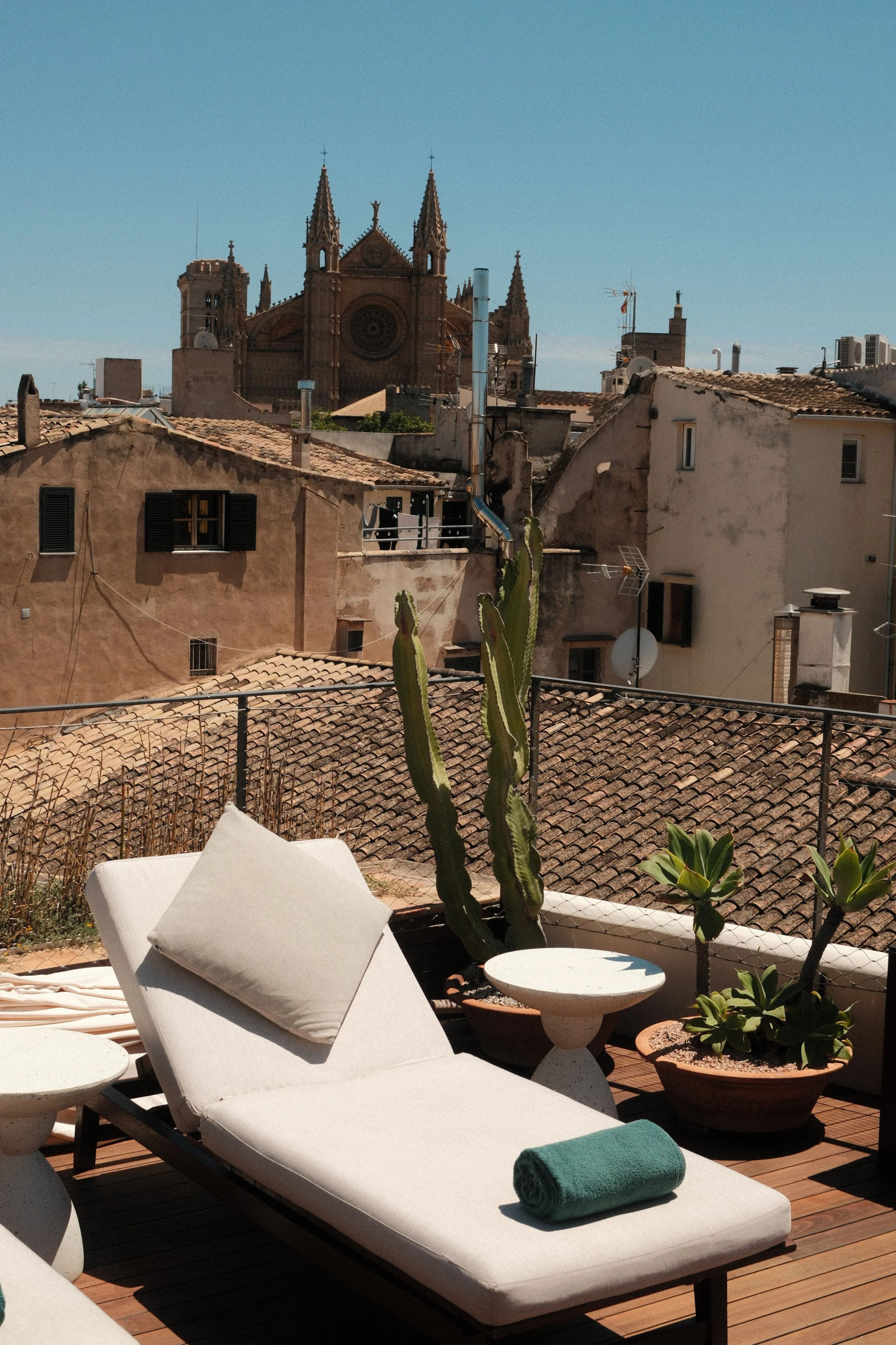 Rooftop sun loungers with cathedral views at Can Bordoy Grand House & Garden