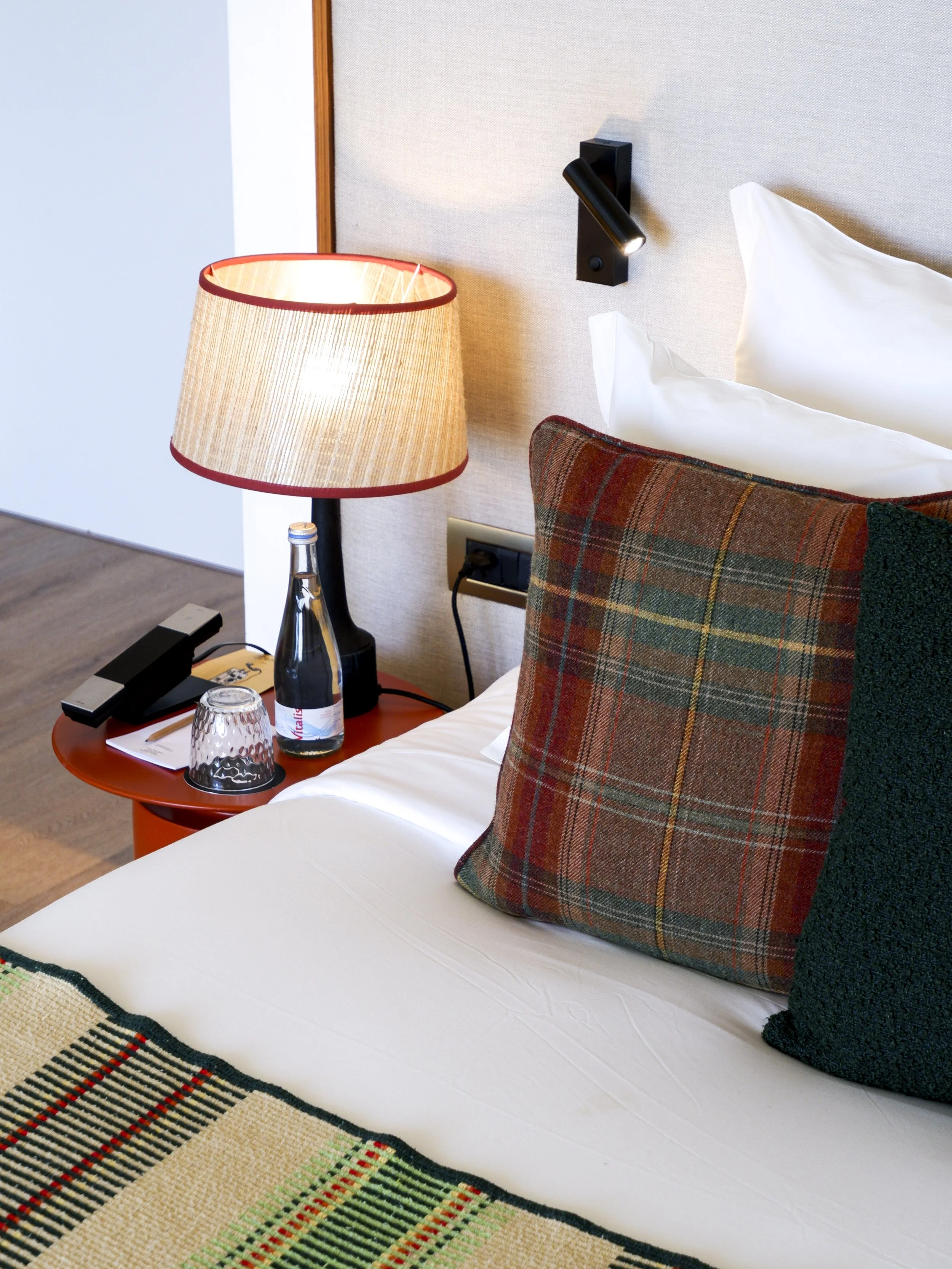 Elegant guest room details featuring premium bedding and warm contemporary décor